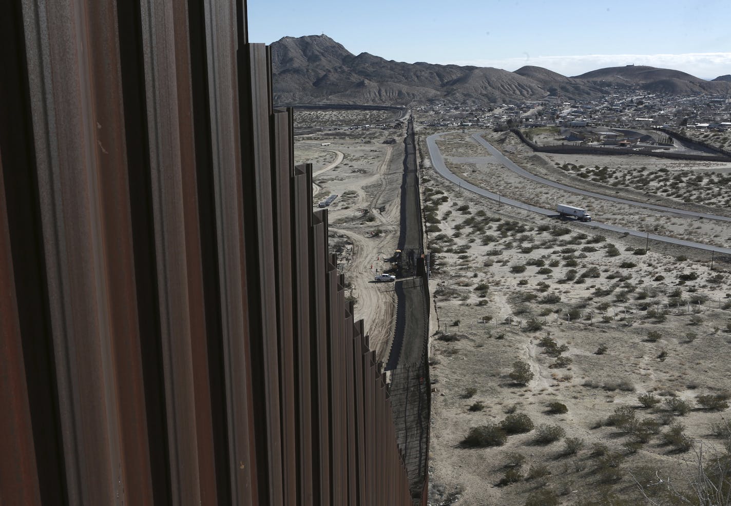 A truck drives near the Mexico-US border fence, on the Mexican side, separating the towns of Anapra, Mexico and Sunland Park, New Mexico, Wednesday, Jan. 25, 2017. U.S. President Donald Trump will direct the Homeland Security Department to start building a wall at the Mexican border. (AP Photo/Christian Torres) ORG XMIT: MXEV101