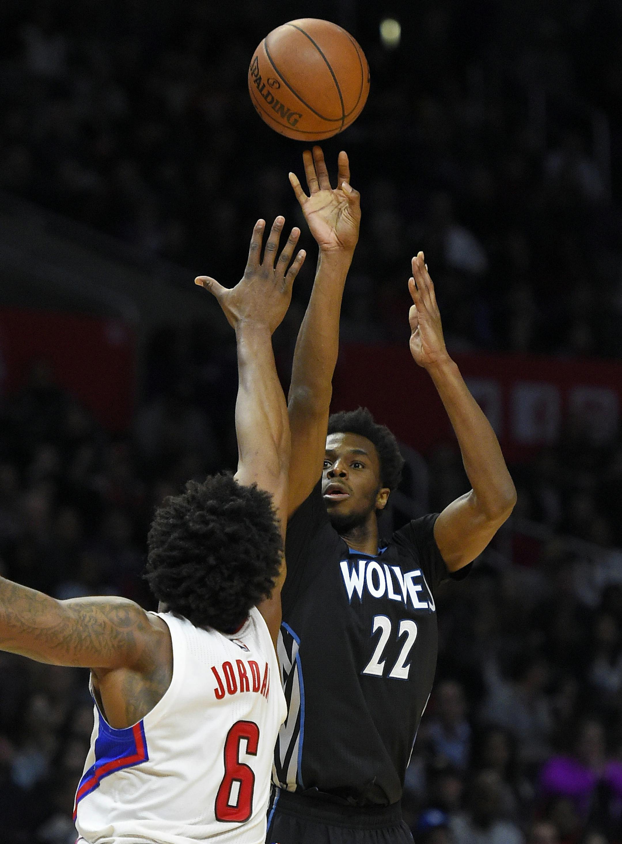 Minnesota Timberwolves guard Andrew Wiggins, right, shoots as Los Angeles Clippers center DeAndre Jordan defends during the second half of an NBA basketball game, Wednesday, Feb. 3, 2016, in Los Angeles. The Timberwolves won 108-102. (AP Photo/Mark J. Terrill)