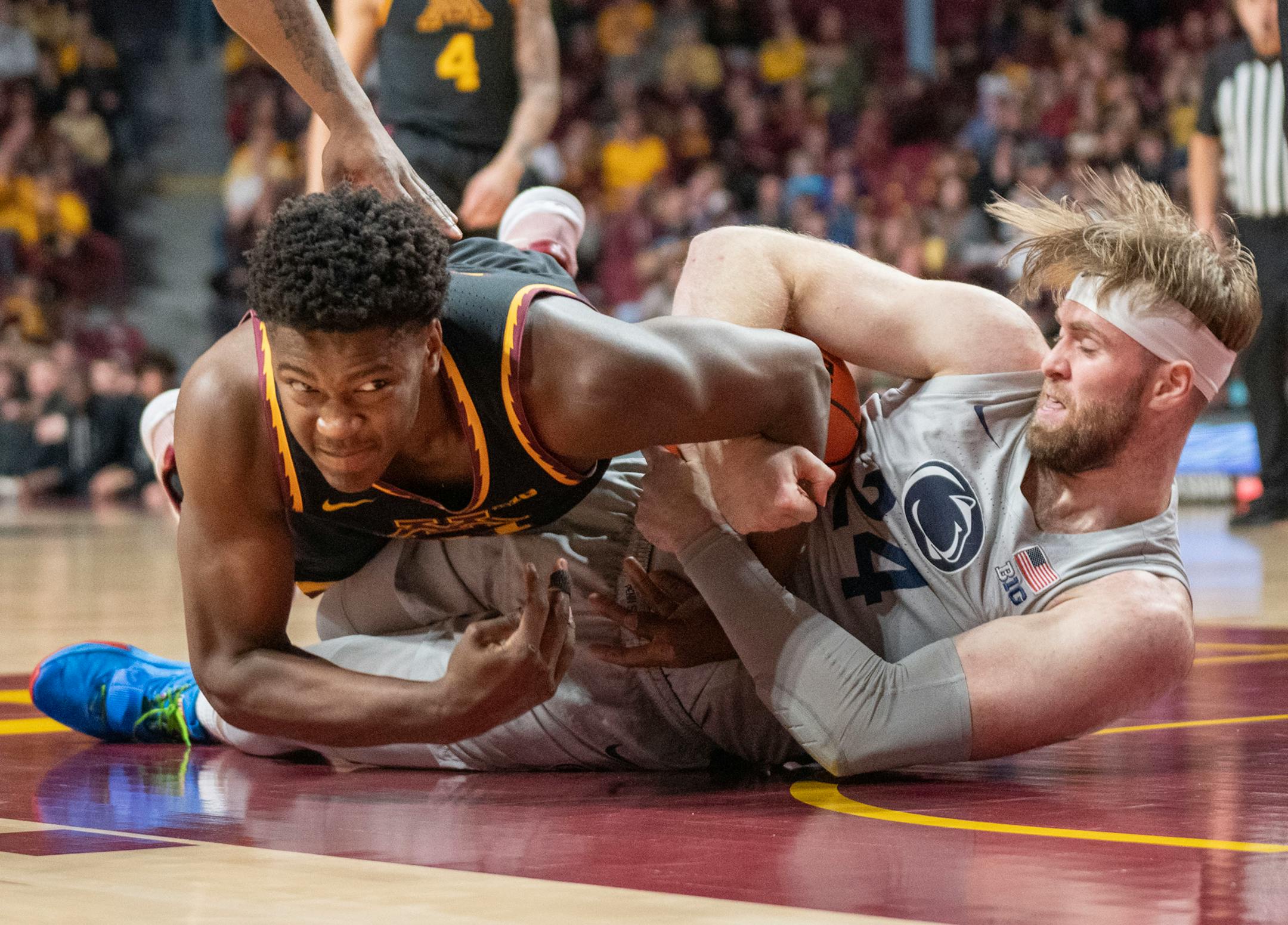 Minnesota forward Pharrel Payne (21) and Penn State forward Michael Henn (24) wrestle for a rebound in the first half Saturday, Feb. 18, 2023 at Williams Arena in Minneapolis.