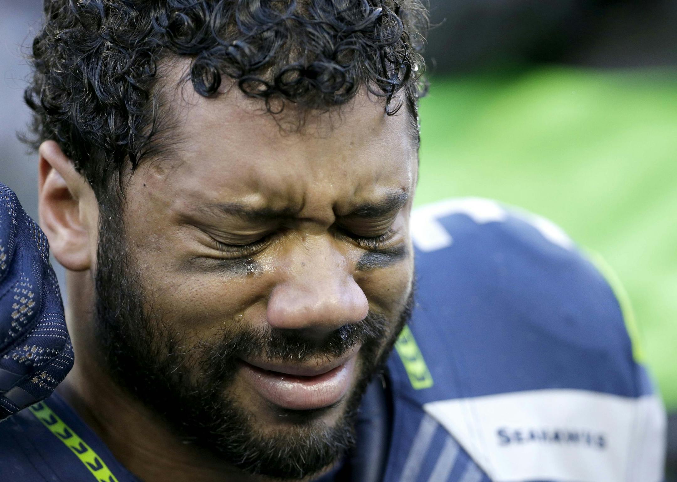 Seattle Seahawks quarterback Russell Wilson cries after the NFL football NFC Championship game against the Green Bay Packers Sunday, Jan. 18, 2015, in Seattle. The Seahawks won 28-22 to advance to Super Bowl XLIX. (AP Photo/David J. Phillip)