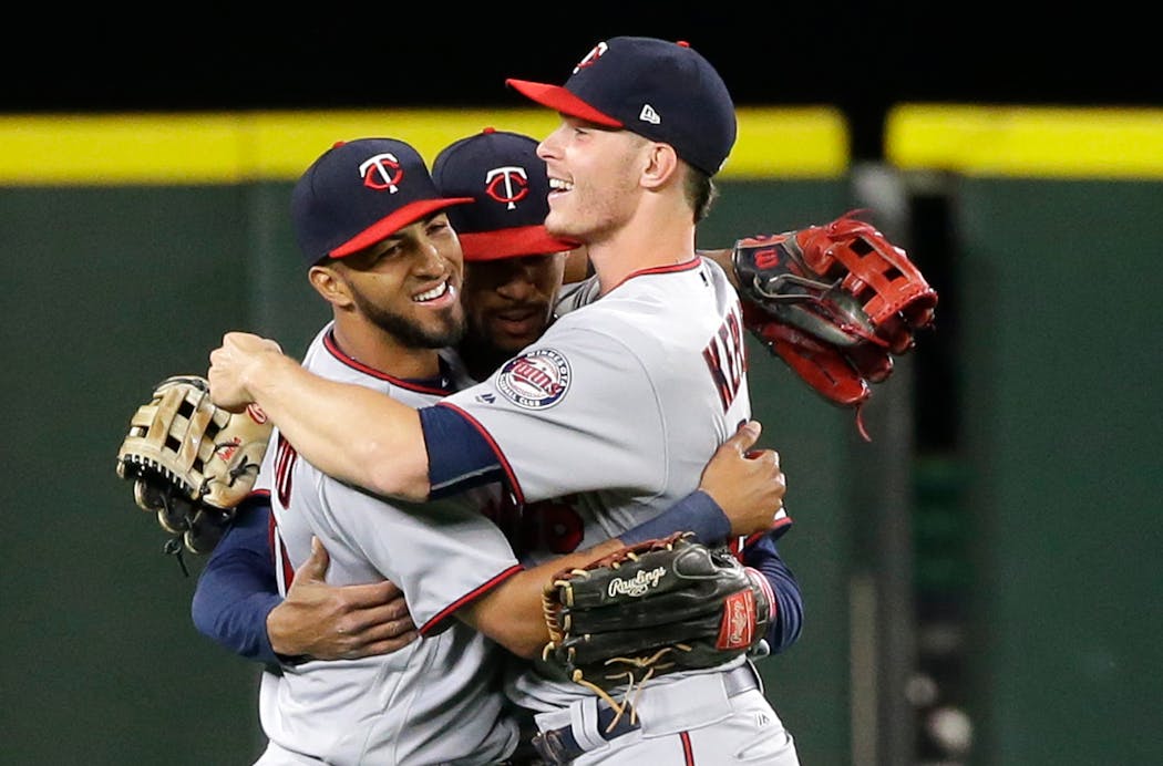 Minnesota Twins outfielders Eddie Rosario, left, Max Kepler, right, and Byron Buxton hug after the Twins defeated the Seattle Mariners 2-1 in a baseball game, Thursday, June 8, 2017, in Seattle. (AP Photo/Ted S. Warren)