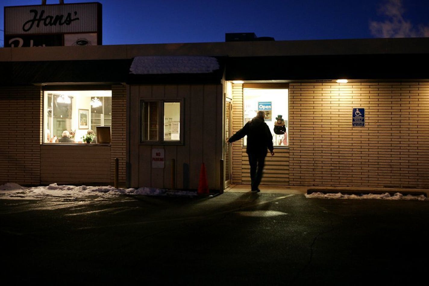 A customer enters Hans� Bakery in Anoka early on a Thursday morning at 6:30 AM, Anoka, Minn., Feb. 23, 2006. The local bakery has been around since 1973 and has many regulars, many of whom have been coming everyday (closed on Sundays) for more than 10 years. Ramin Rahimian � rrahimian@startribune.com GENERAL INFORMATION: Feature on an Anoka institution, Hans' Bakery, which has been there since 1973, and which continues to last while Krispy Kremes come and go. These are regulars.