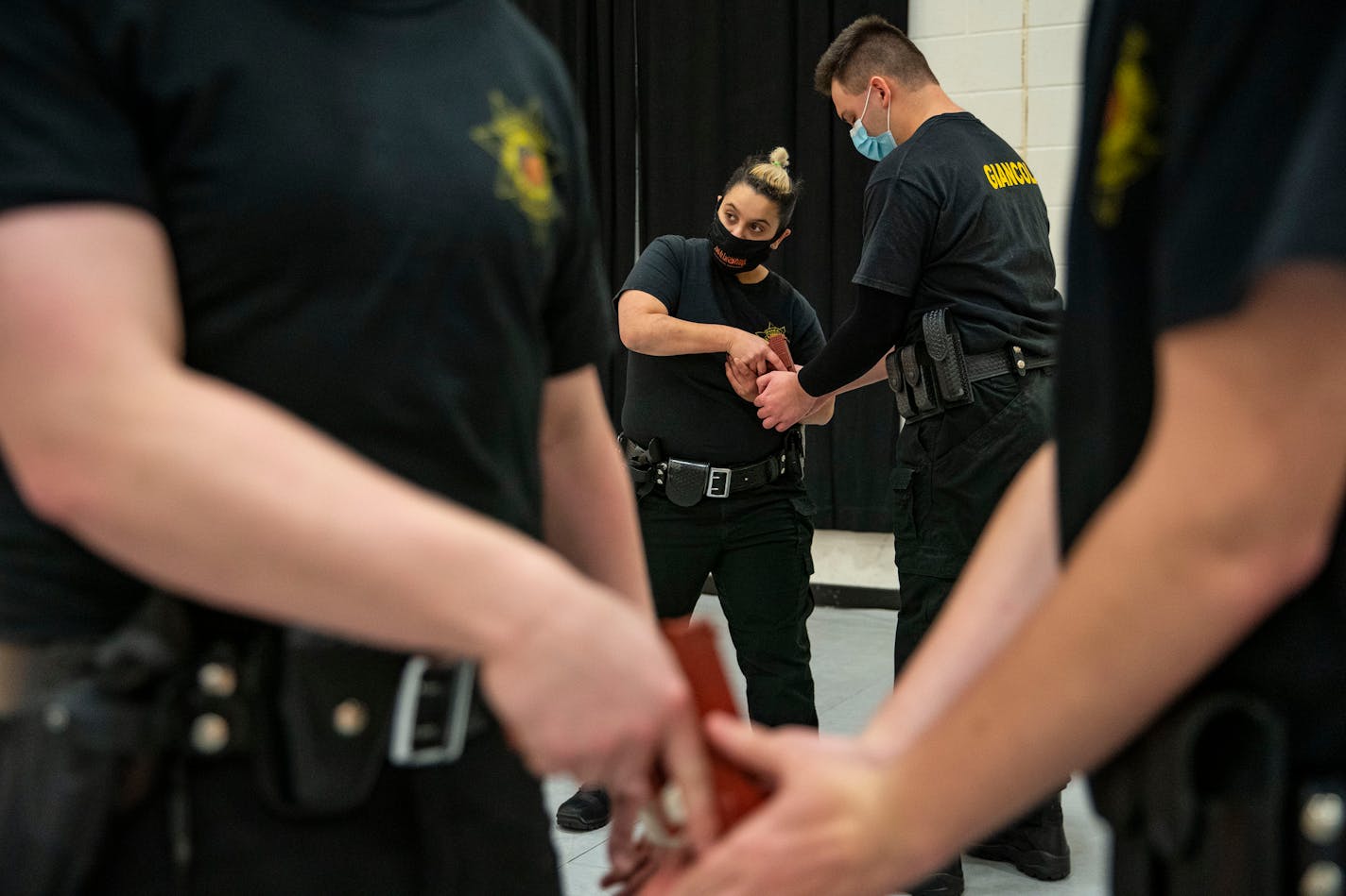 (From left) Law Enforcement trainees Mona Zeidan and Dariano Giancola practiced breaking each other's grips on the barrel of a practice gun during law enforcement training. Defensive tactics class took place in the gymnasium at Fond Du Lac Tribal and Community College in Cloquet, Minn. on Tuesday November 17, 2020. ]