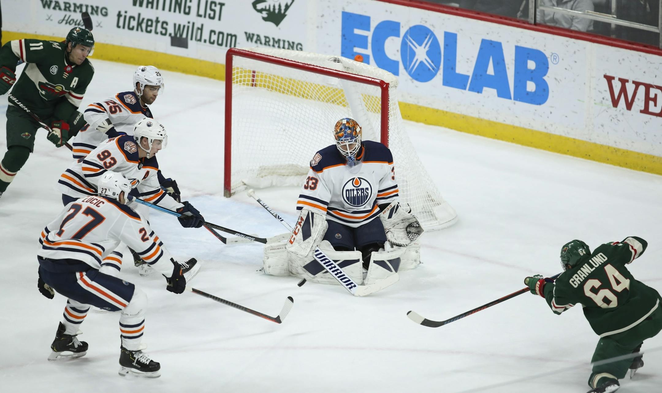 Minnesota Wild right wing Mikael Granlund (64) shot on Edmonton Oilers goaltender Cam Talbot (33) in the third period with Wild left wing Zach Parise (11) and a trio of Oilers awaiting the rebound.