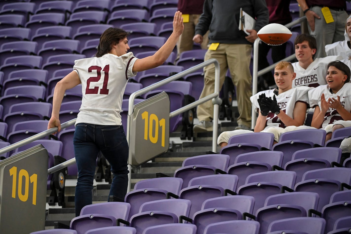 Chatfield quarterback Sam Backer (21), who was ineligible to play after being disqualified due to two unsportsmanlike conduct penalties in the semifinal game, tossed a football to teammates before taking a group photo after the Class 2A state tournament championship football game between Chatfield and West Central Area/Ashby Friday, Nov. 26, 2021 at U.S. Bank Stadium in Minneapolis, Minn. Chatfield defeated West Central Area/Ashby 14-13. ] AARON LAVINSKY • aaron.lavinsky@startribune.com