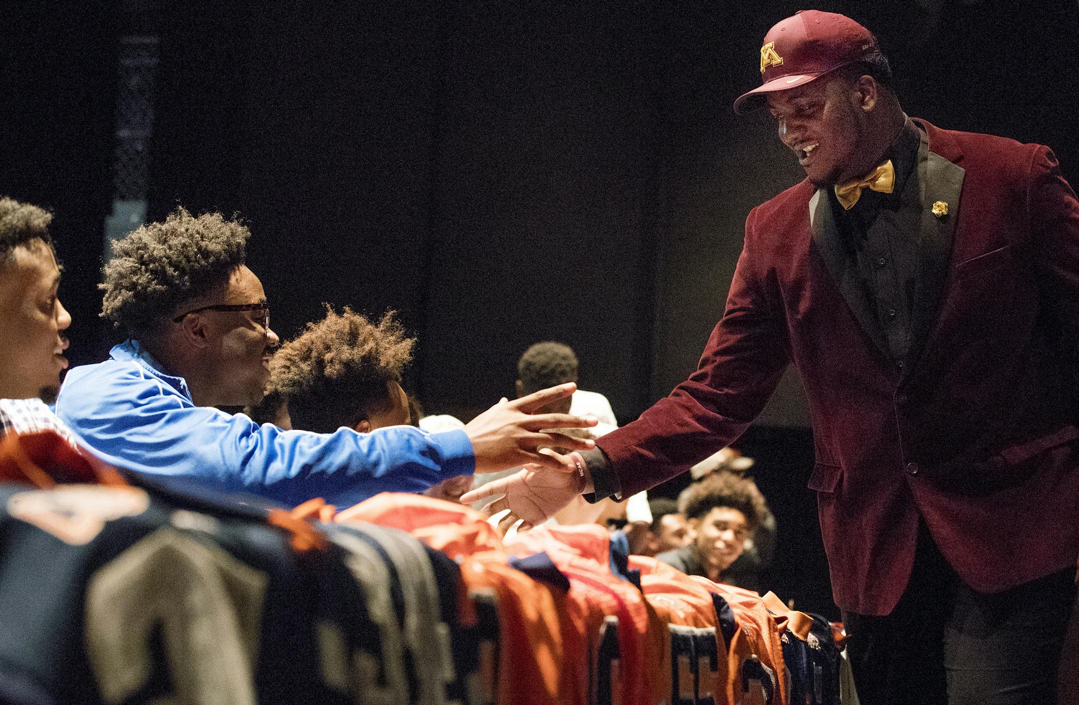 Eric Abojei greeted fellow collegiate bound athletes after taking the stage. Cooper High School offensive lineman Eric Abojei has committed to the University of Minnesota Golden Gophers. ] CARLOS GONZALEZ cgonzalez@startribune.com - February 1, 2017, New Hope, MN, Cooper High School, signing day at Cooper, focus on University of Minnesota bound Eric Abojei,