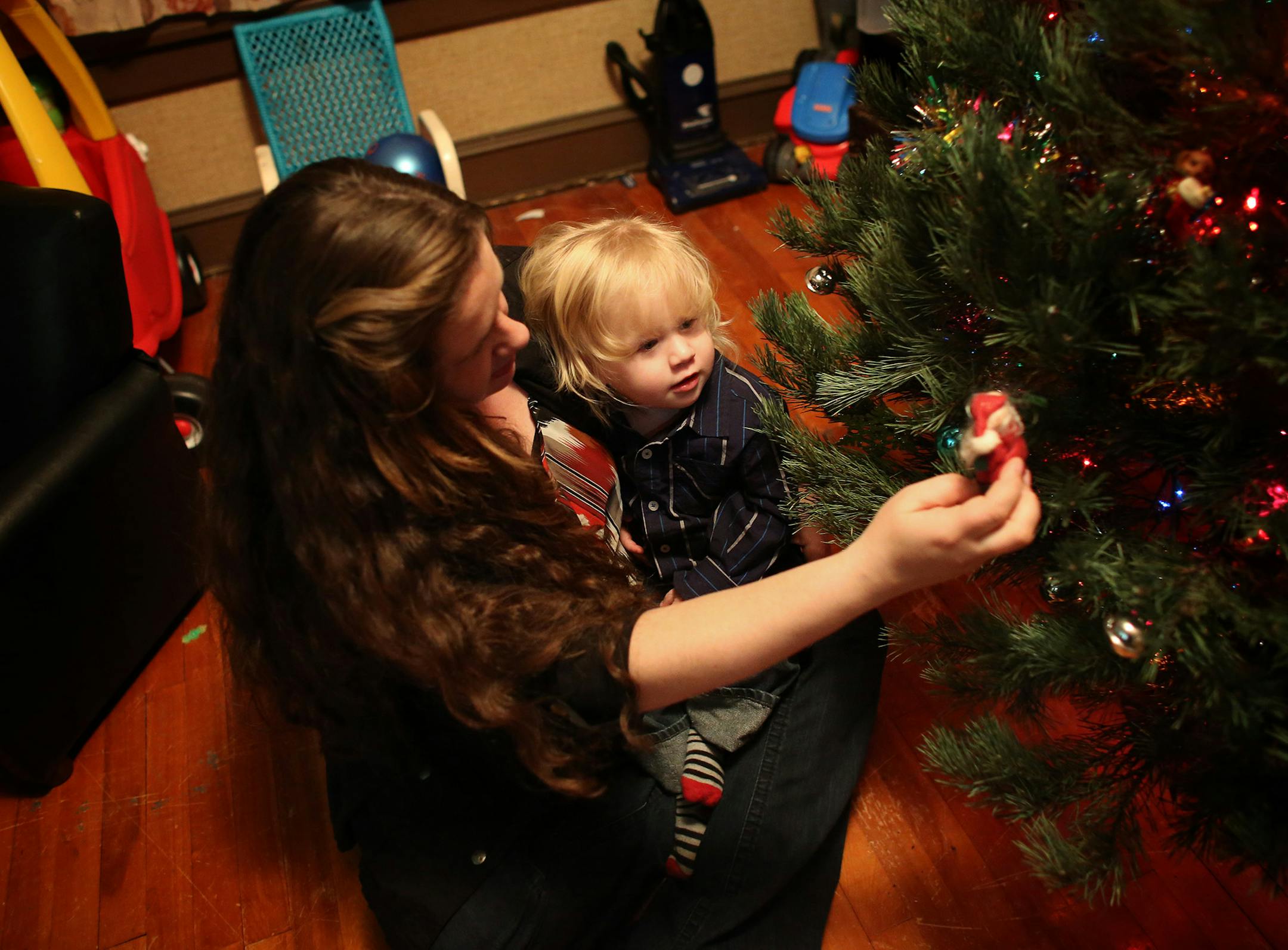 First-time homeowner Lindsey Towler and her son, Drew Kjornes, decorated a Christmas tree in the house she bought with help from the City Of Lakes Community Land Trust.