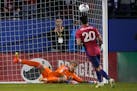 FC Dallas forward Alan Velasco (20) scores a goal against Minnesota United goalkeeper Dayne St. Clair (97) in a shoot-out after overtime play after an