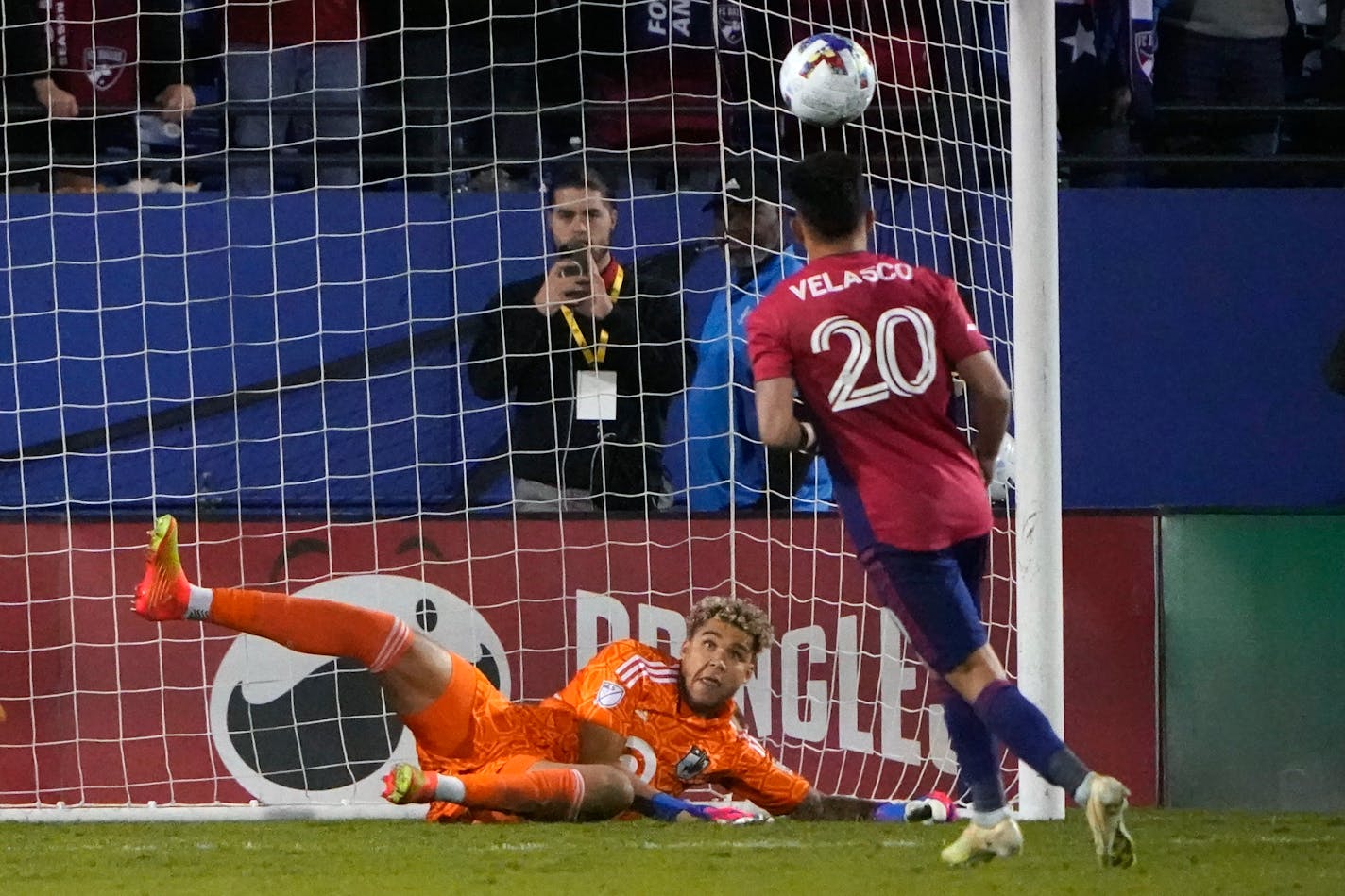 FC Dallas forward Alan Velasco (20) scores a goal against Minnesota United goalkeeper Dayne St. Clair (97) in a shoot-out after overtime play after an MLS soccer playoff match in Frisco, Texas, Monday, Oct. 17, 2022. The teams tied 1-1 with Dallas winning 5-4 in penalties. (AP Photo/LM Otero)