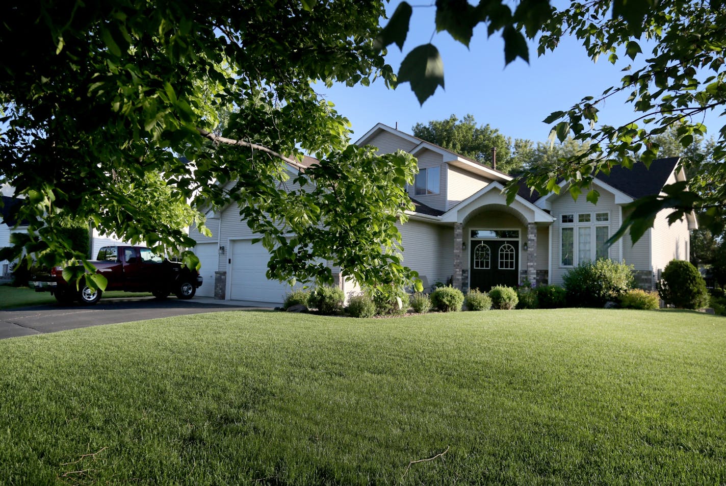 The immaculately cared for yard and home where three people were found dead in Andover.