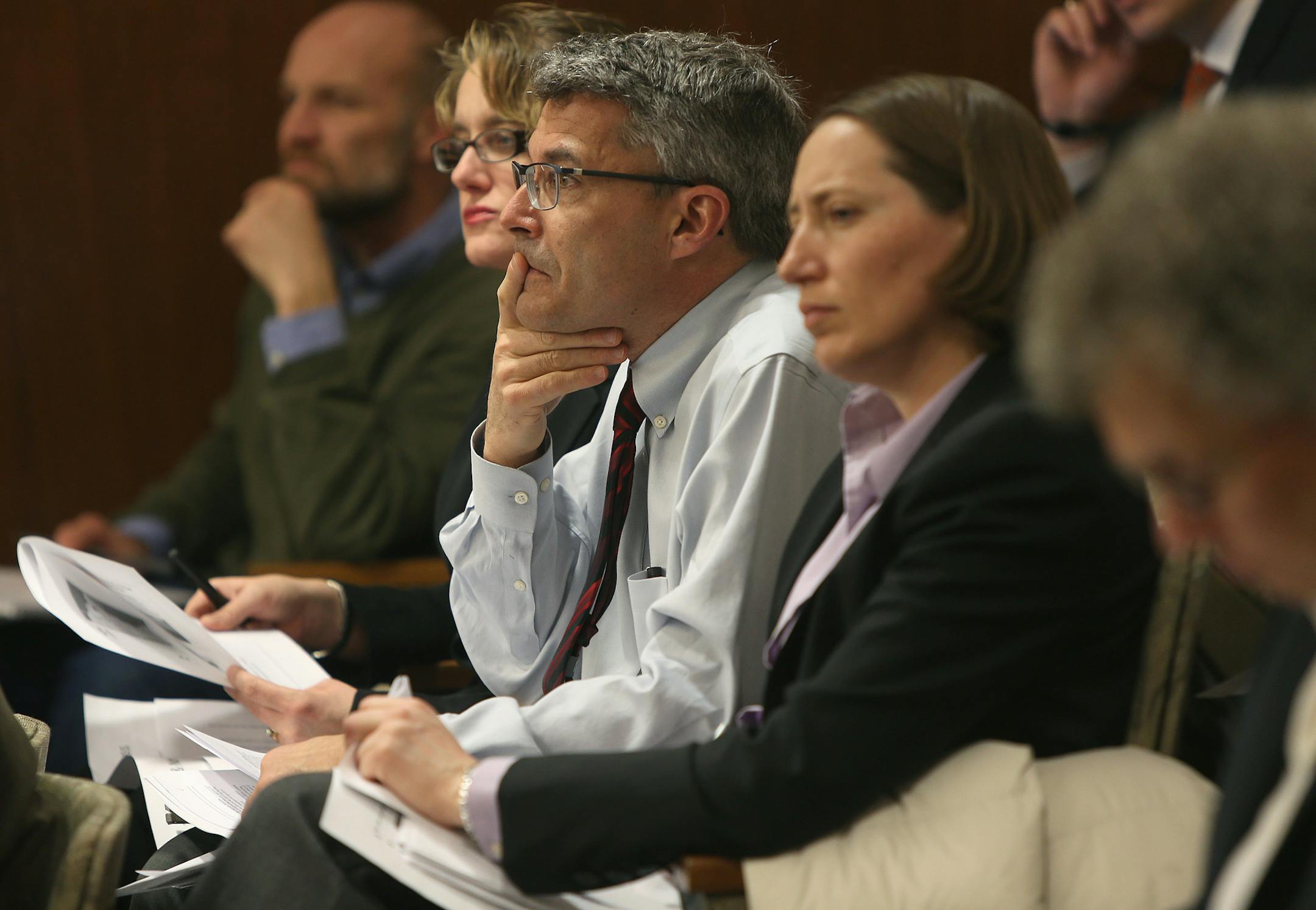 Brad Moore, center, executive vice president of PolyMet Mining Corp., listened to Jess Richards, director of the Division of Lands and Minerals, as he answered questions at a meeting for the Environment, Natural Resources and Agriculture Finance Committee, Tuesday, Feb. 11, 2014 at the State Office Building in St. Paul.