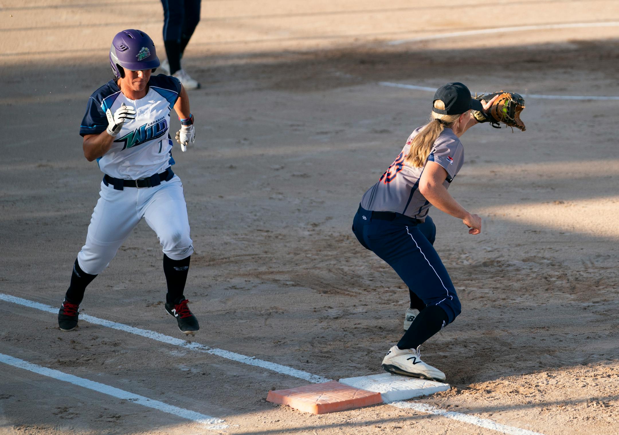 Aussie Peppers' Chelsea Forkin (25) caught the ball for an out for Canadian Wild batter Jennifer Salling (7) during a game in North Mankato, Minn. Wednesday, July 3, 2019. ] RENEE JONES SCHNEIDER ¥ renee.jones@startribune.com