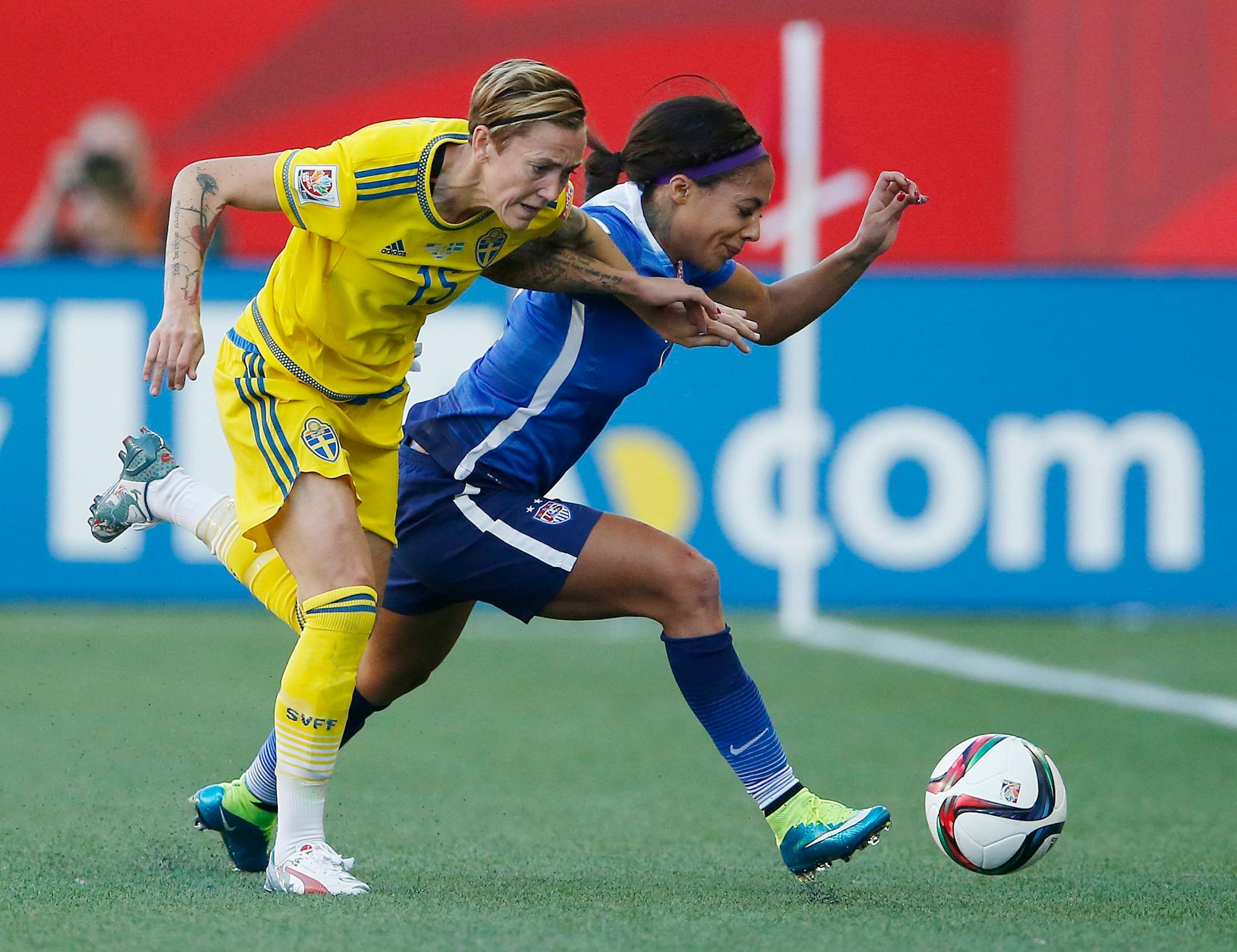 Sweden's Therese Sjogran (15) and United States' Sydney Leroux chase down the ball during first-half FIFA Women's World Cup soccer game action in Winnipeg, Manitoba, Canada, Friday, June 12, 2015. (John Woods/The Canadian Press via AP) MANDATORY CREDIT
