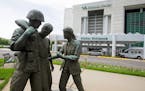 In this June 9, 2014 file photo is a sculpture portraying a wounded soldier being helped on the grounds of the Minneapolis VA Hospital.