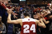 Wisconsin's Bronson Koenig is congratulated by fans as he leaves the court after hitting a three-point basket at the buzzer to defeat Xavier in a seco
