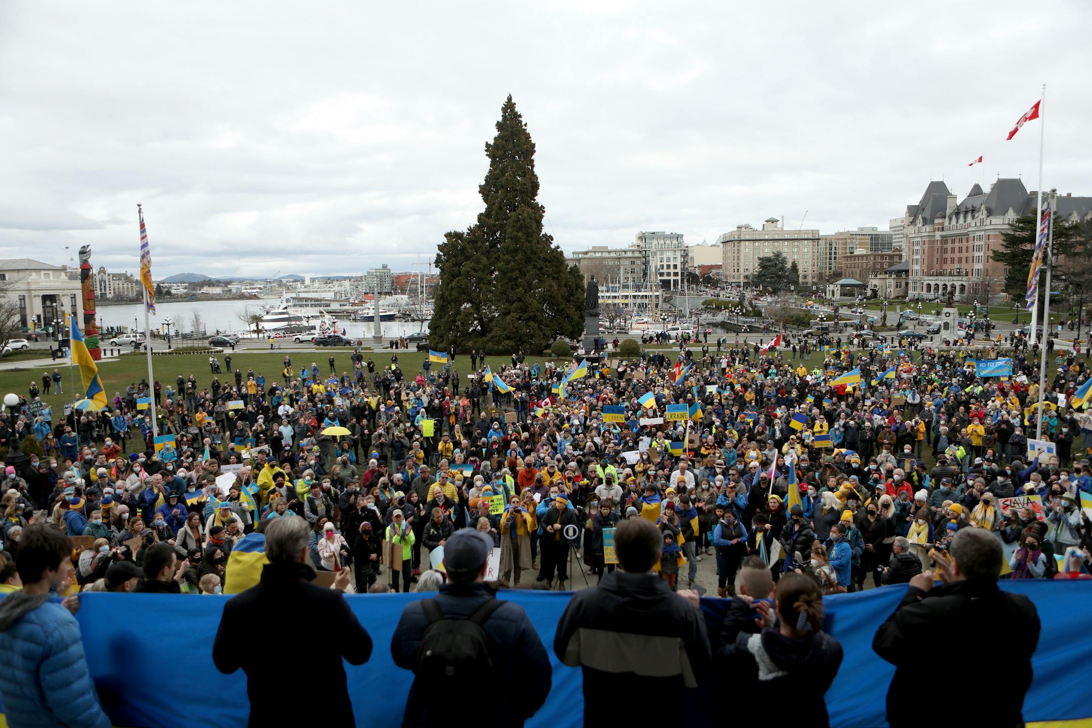 Hundreds of people gather in solidarity with the people of Ukraine during a rally organized by the Ukrainian Canadian Congress on the steps of the British Columbia Legislature in Victoria, Sunday, Feb. 27, 2022. (Chad Hipolito/The Canadian Press via AP)