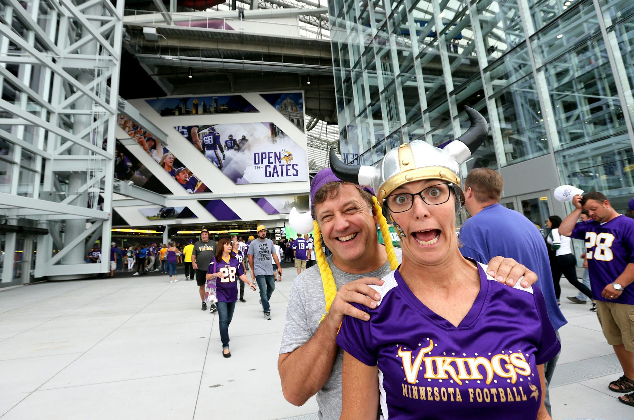 Todd and Mindi Hansen of Edina, longtime Vikings season-ticket holders, clowned in front of U.S. Bank Stadium as the giant glass doors opened to fans.