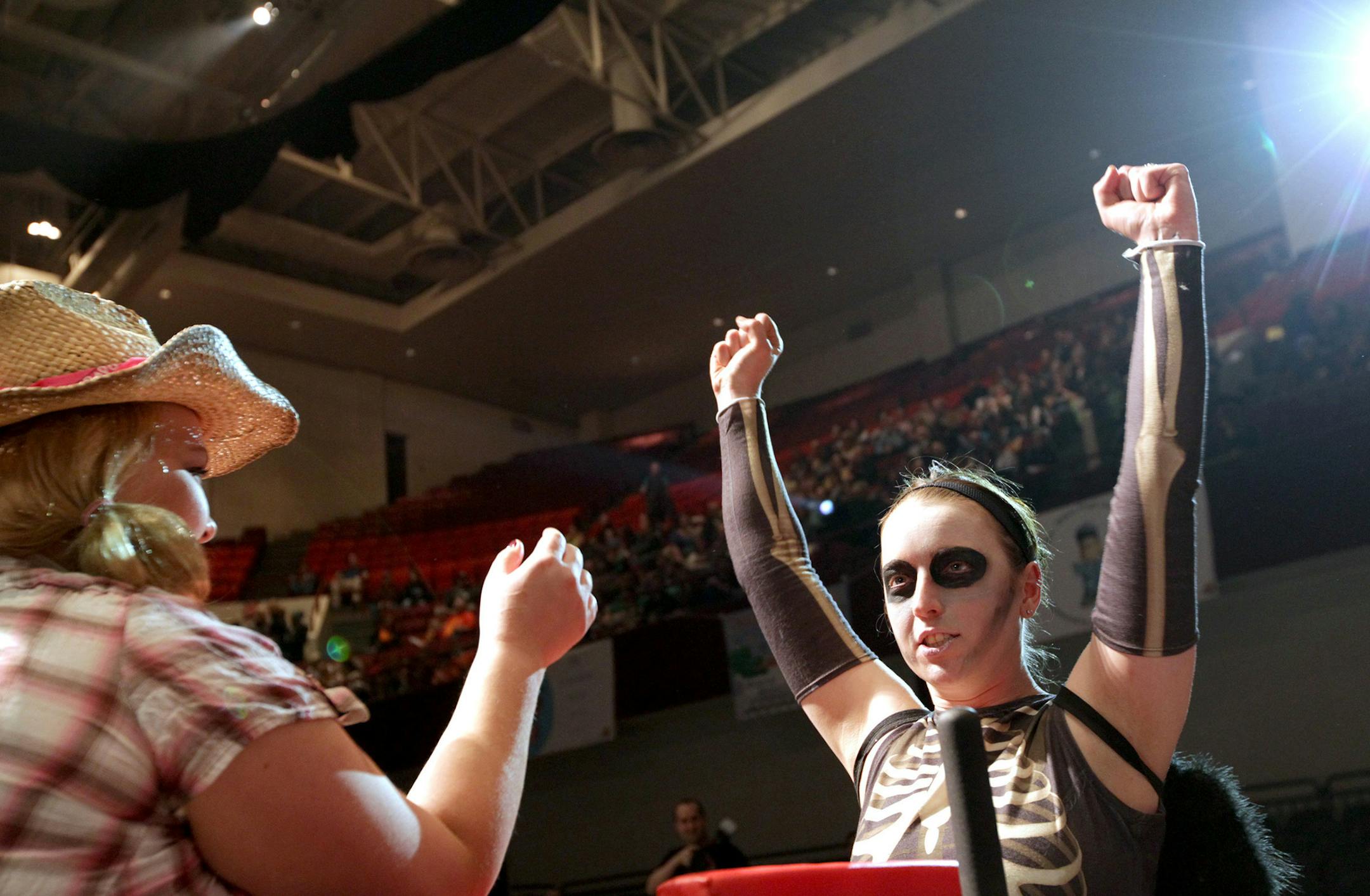 Angela "Death" Hershberger, right, celebrates her win as the Minnesota Arm Wrestling League for Ladies holds a brief set of matches at the Minnesota Roller Girls tournament at Roy Wilkins Auditorium in St. Paul March 2, 2013. (Courtney Perry/Special to the Star Tribune)