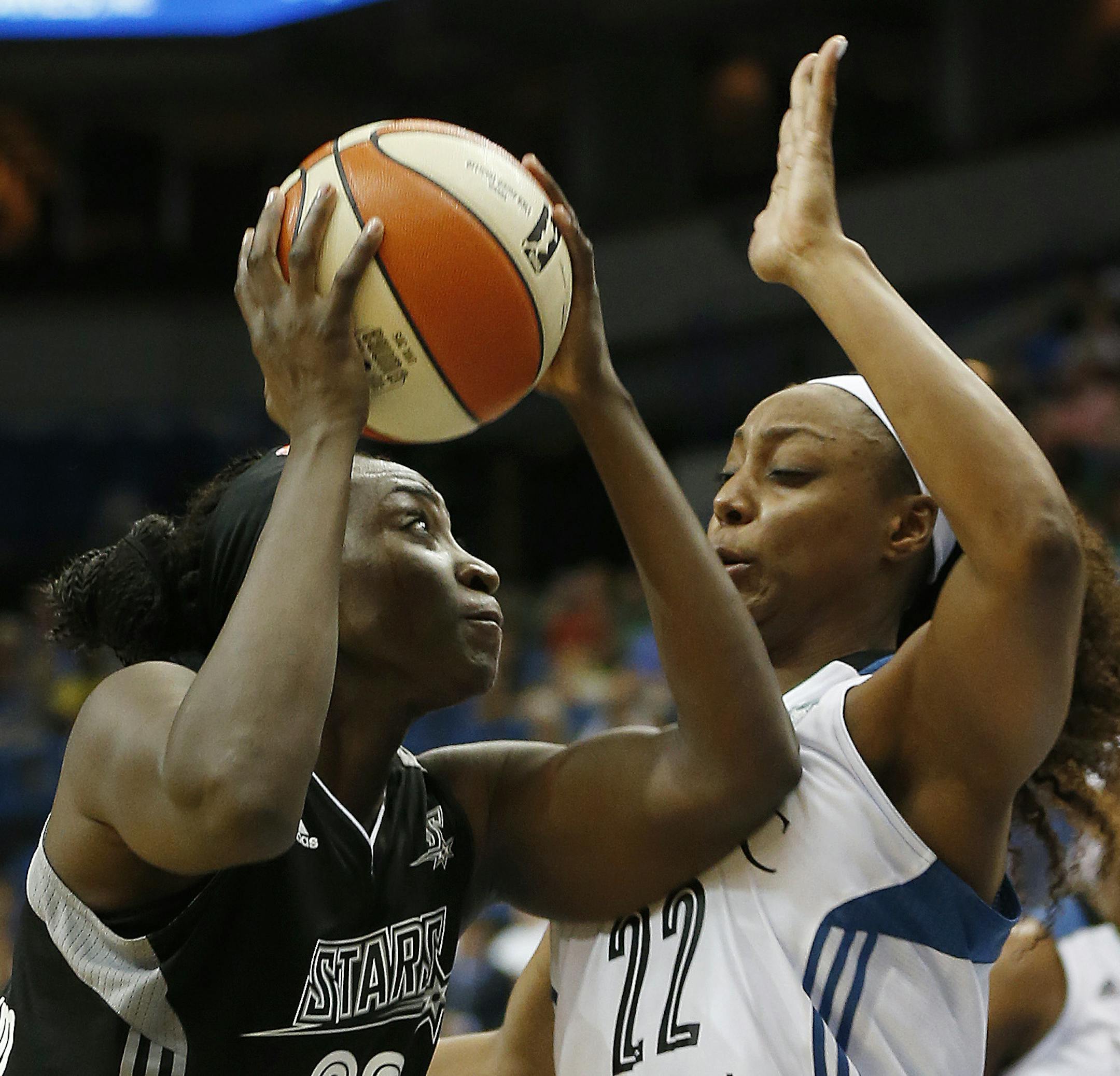 San Antonio Stars forward Sophia Young-Malcolm (33) tries to push the ball up to the basket against Minnesota Lynx guard Monica Wright (22) during the first half of a WNBA basketball game, Sunday, July 12, 2015, in Minneapolis. (AP Photo/Stacy Bengs)