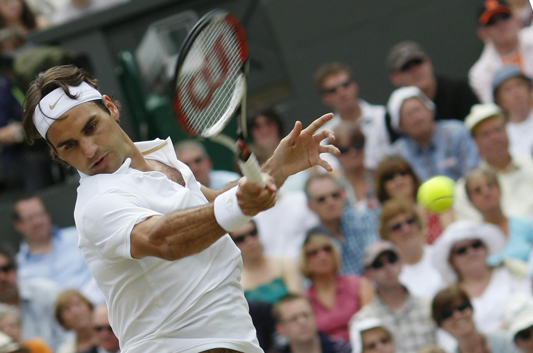 Roger Federer returns the ball during his semi-final tennis match of the 2008 Wimbledon championships against Russia's Marat Safin at The All England Tennis Club in southwest London, on July 4, 2008.