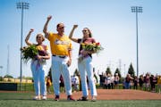 Gophers baseball coach John Anderson, center, accompanied by wife, Jan, and daughter, Erin, chant the “Rouser” at Anderson’s retirement celebrat