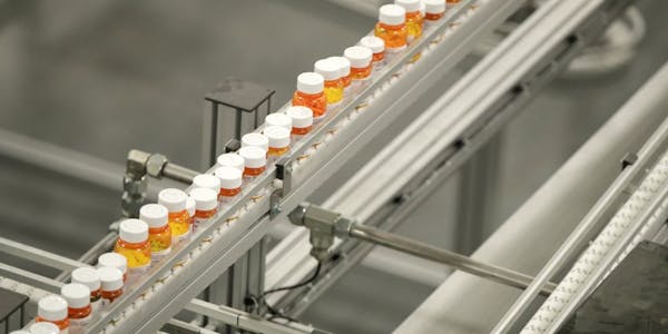 FILE- In this July 10, 2018, file photo bottles of medicine ride on a belt at a mail-in pharmacy warehouse in Florence, N.J. Drug companies are still 
