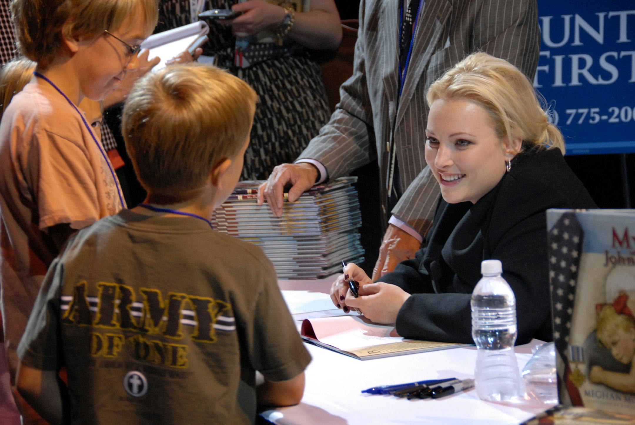 Taylor Eide, 12, and Ethan Eide, 7, talked with author Meghan McCain as she signed copies of her book, "My Dad, John McCain" at CivicFest at the Minneapolis Convention Center. The Eide family is from Lakeville. Taylor Eide read the book while standing in line.