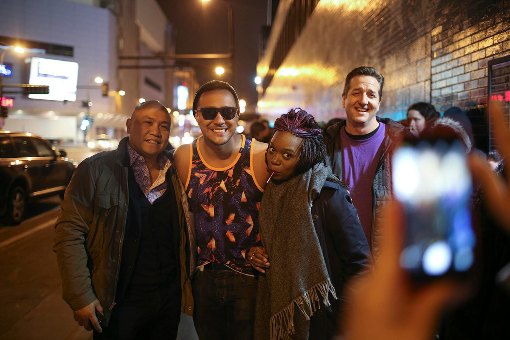 Patrick Rosal of Philadelphia, Aaron Samuels fromLos Angeles, Syreeta McFadden from New York, and Jason Carney from Dallas posed for a photo by a friend while waiting for the doors to open for The Prince Purple Poetry Party Wednesday night at First Ave. ] JEFF WHEELER • jeff.wheeler@startribune.com One of the off-site events at the start of the AWP Conference & Bookfair was The Prince Purple Poetry Party Wednesday night, April 8, 2015 in The Record Room at First Ave. in Minneapolis. More than a