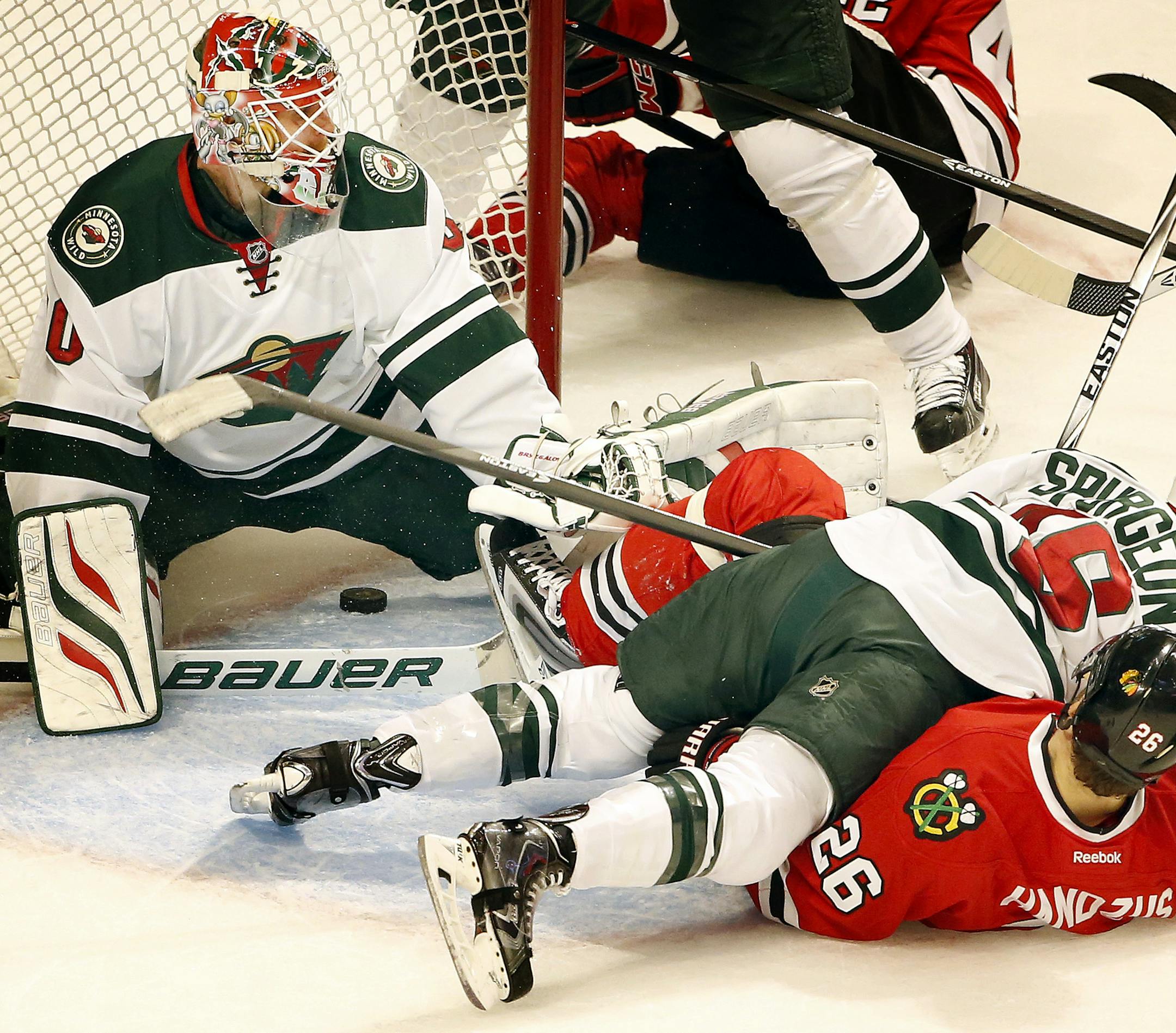 The puck sat under and out of the view of Wild goalie Ilya Bryzgalov (30) in the second period. ] CARLOS GONZALEZ cgonzalez@startribune.com - May 2, 2014, Chicago, Illinois, United Center, NHL, Minnesota Wild vs. Chicago Blackhawks, Stanley Cup Playoffs Round 2, Game 1