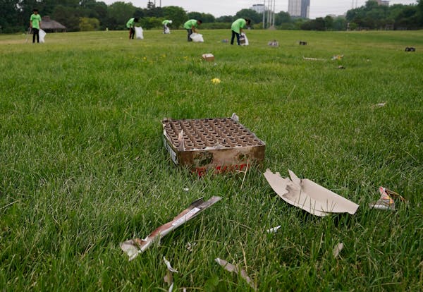 Workers from Teen Teamworks picked up litter, including remnants of exploded fireworks, at Boom Island Park in Minneapolis the day after gunfire at th
