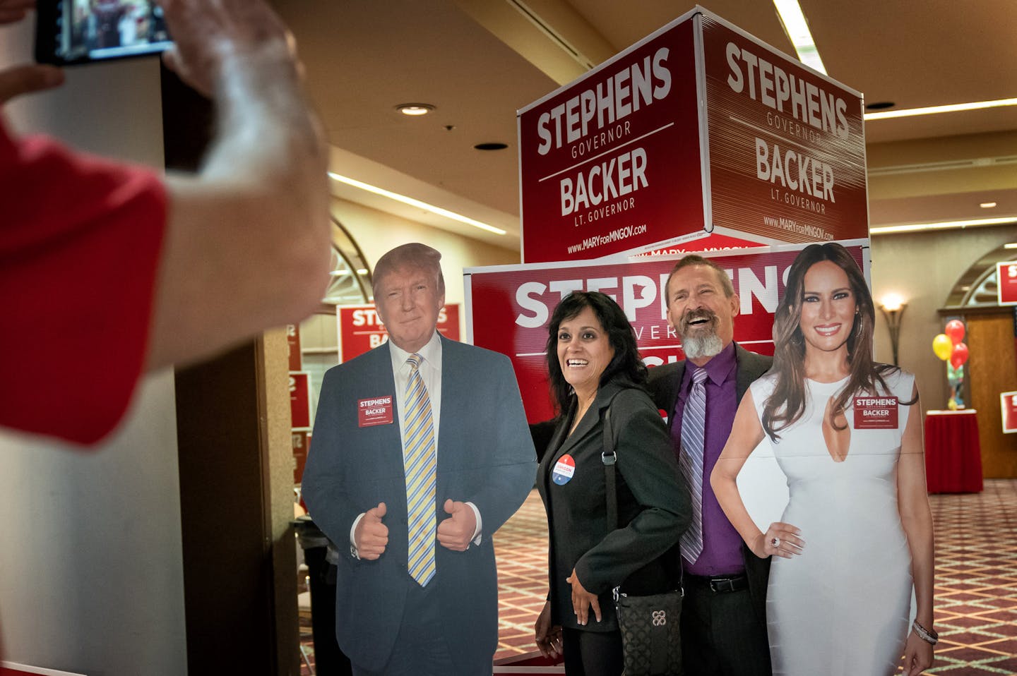 Maria Rosario and Bill Jungbauer, delegates from Inver Grove Heights wanted to take their photo by cutouts of President Trump and First Lady Melania Trump at the Republican state convention in Duluth.