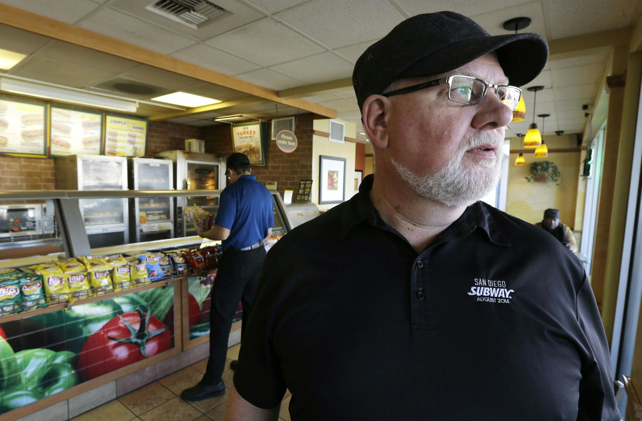 David Jones looks out the window of one of the two Subway sandwich franchises he owns, Tuesday, March 3, 2015, in Seattle. Jones, who has 18 employees at his two stores, says he will need to raise prices 4 percent to cover the first pay increase mandated by Seattle's minimum wage law. (AP Photo/Ted S. Warren) ORG XMIT: NYBZ106