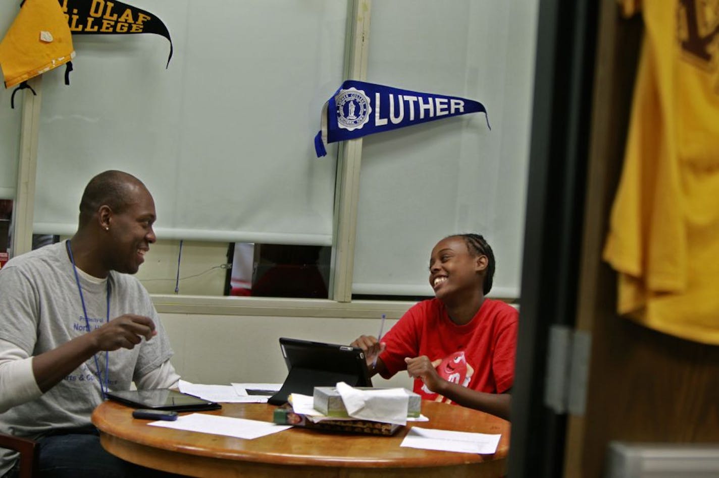 Counselor Derek Francis helped student Renee Parks, 14, with an assignment at the new Academy of Arts and Communications program at North High School. The school has a new principal, an outside consultant that's a first for Minneapolis and a new class of freshmen.