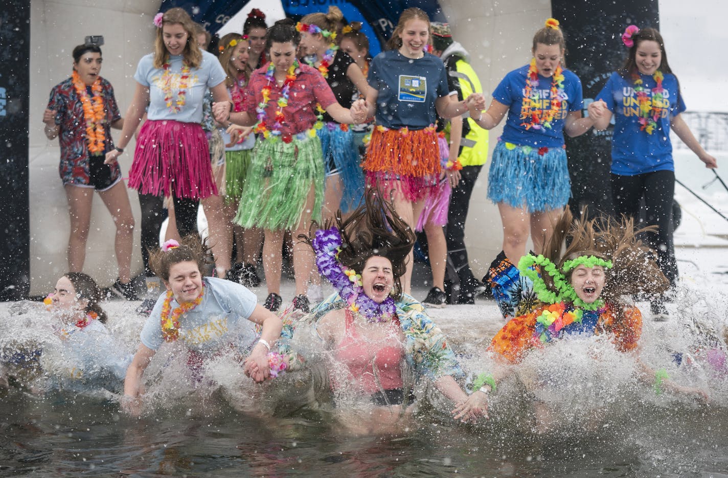 Students from Wayzata High School participate in the Cool School Plunge. ] LEILA NAVIDI &#xa5; leila.navidi@startribune.com BACKGROUND INFORMATION: Cool School Plunge + Super Plunge, part of the Minneapolis Polar Plunge's Frozen Friday events at Thomas Beach on Bde Maka Ska in Minneapolis on Friday, March 1, 2019. Snow accumulating 2-4 inches is predicted for the first day of March, followed by cold temperatures.