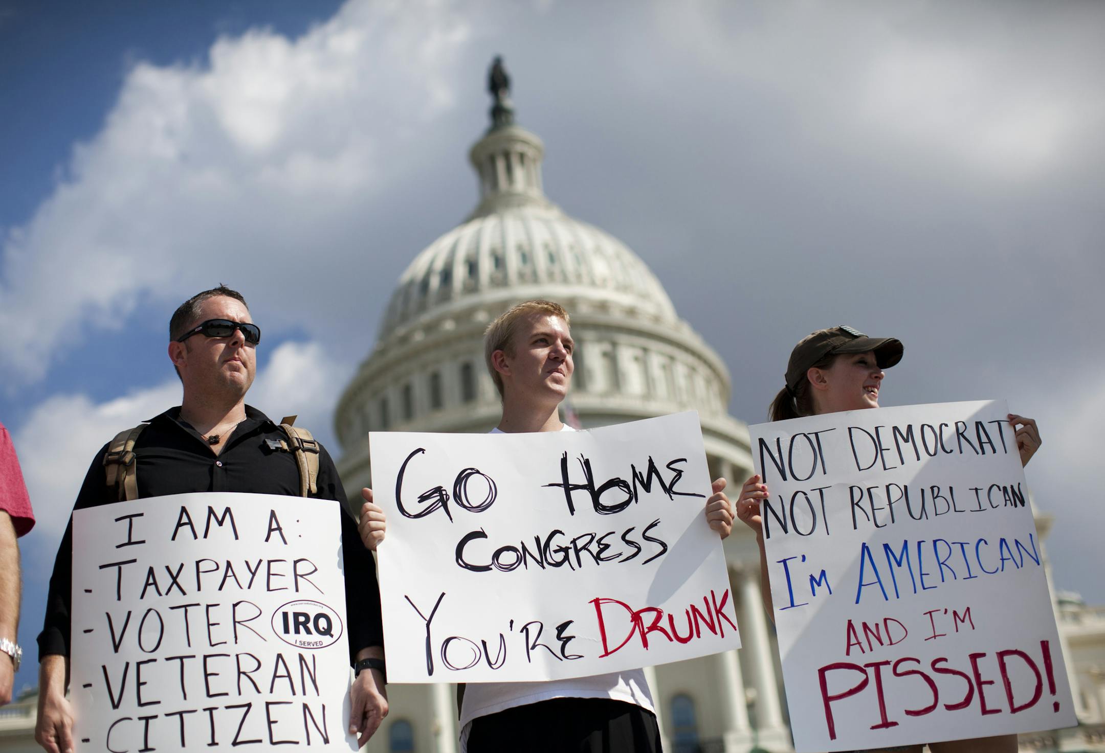 Protestors holds signs against the government shutdown on the West Front of the U.S. Capitol building on Capitol Hill on Friday, Oct. 4, 2013 in Washington.