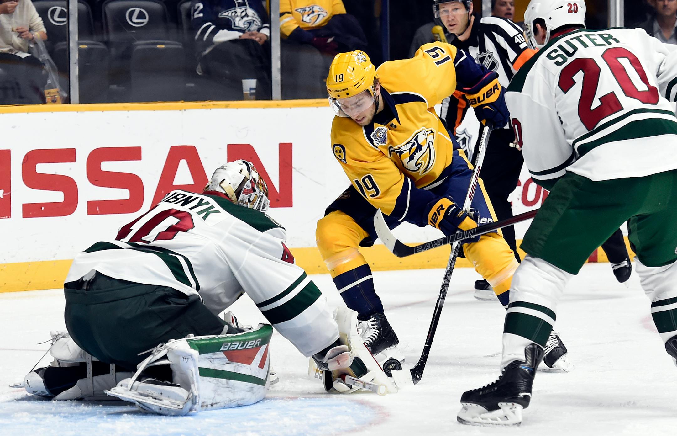 Minnesota Wild goalie Devan Dubnyk (40) blocks a shot by Nashville Predators center Calle Jarnkrok (19),of Sweden, in the second period of an NHL hockey game Saturday, Dec. 19, 2015, in Nashville, Tenn. (AP Photo/Mark Zaleski)