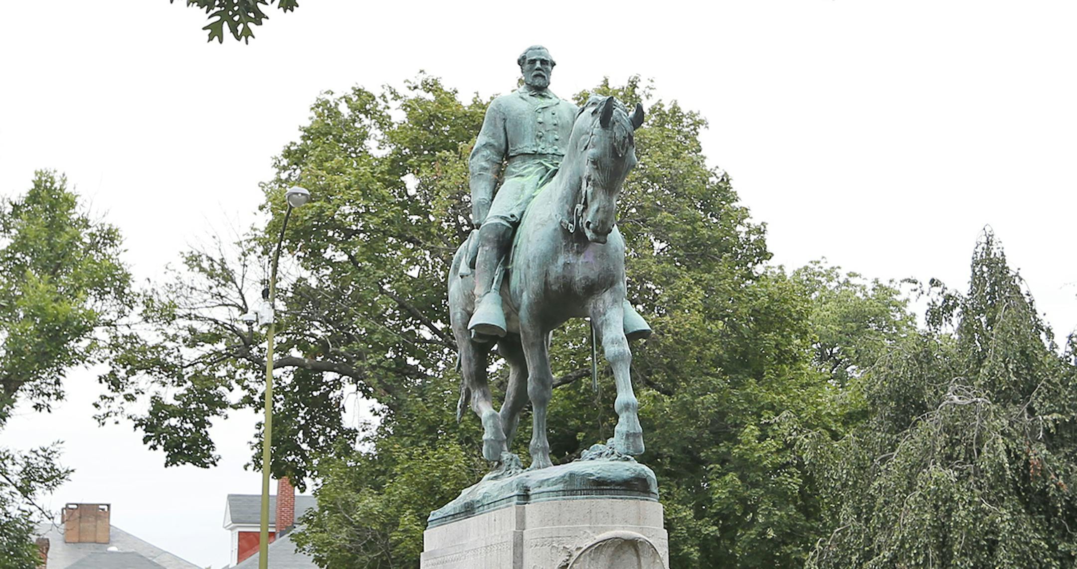 The statue of Confederate General Robert E. Lee still stands in Lee park in Charlottesville, Va., Monday, Aug. 14, 2017. The removal of the statue is in litigation and is at the center of the racial tensions and demonstrations in the town. (AP Photo/Steve Helber) ORG XMIT: MIN2017081517171020