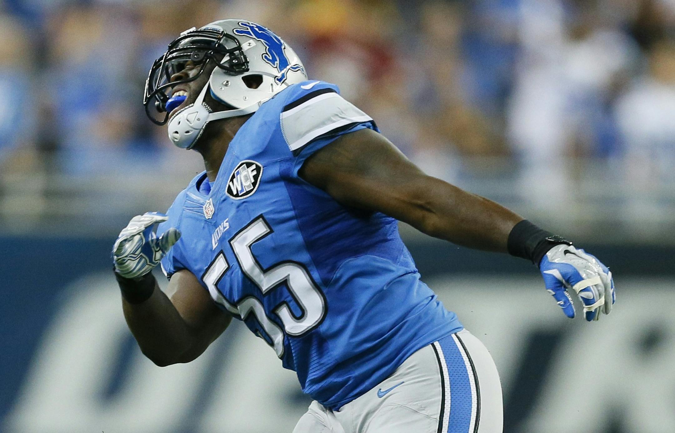 Detroit Lions middle linebacker Stephen Tulloch (55) celebrates his sack of Green Bay Packers quarterback Aaron Rodgers (12) during the first half of an NFL football game in Detroit, Sunday, Sept. 21, 2014. Tulloch injured his left knee celebrating. (AP Photo/Rick Osentoski) ORG XMIT: DTF130