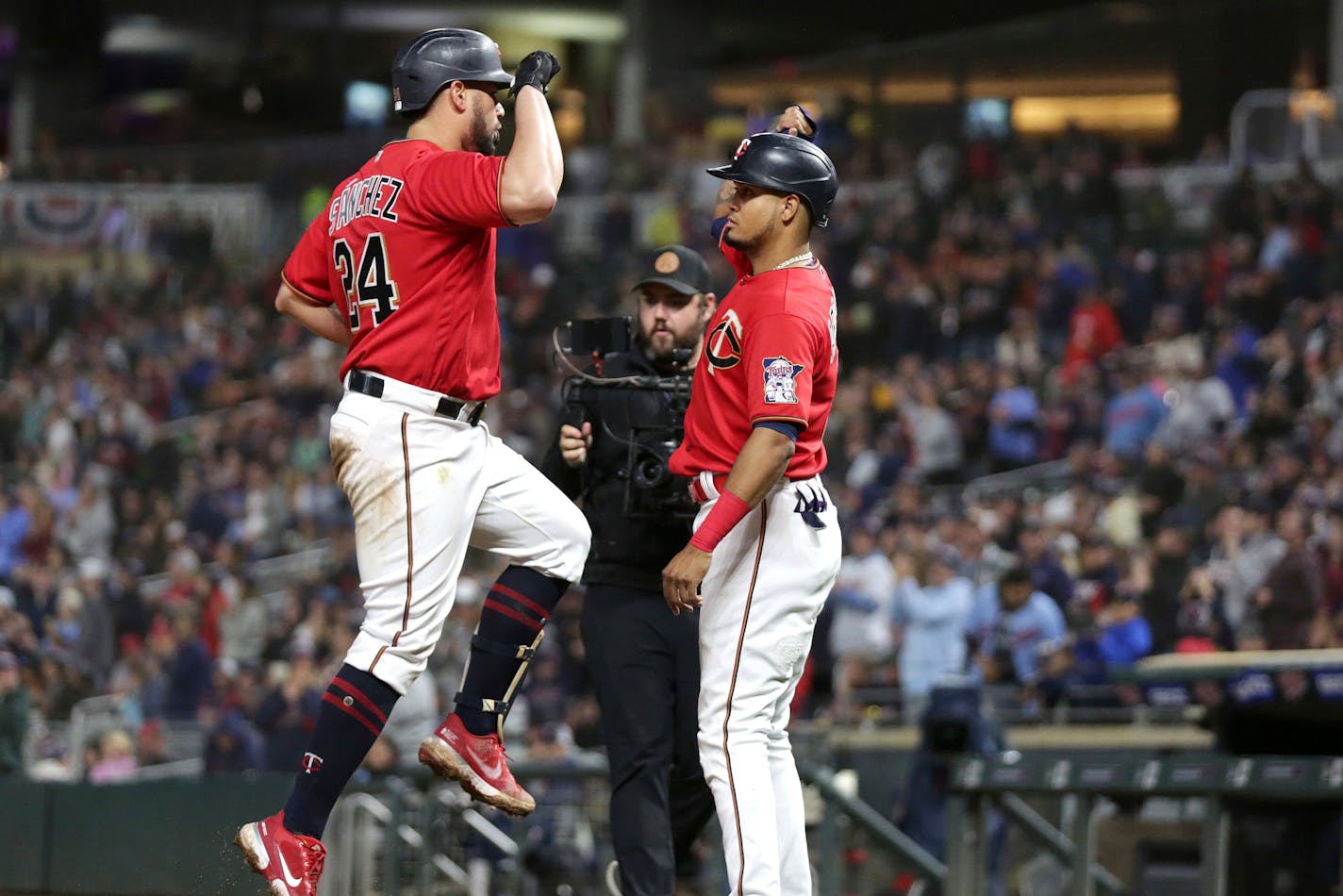 Minnesota Twins catcher Gary Sanchez (24) celebrates with Minnesota Twins first baseman Luis Arraez (2) after hitting a 3-run home run against the Los Angeles Angels in the fifth inning of a baseball game Saturday, Sept. 24, 2022, in Minneapolis. (AP Photo/Andy Clayton-King)