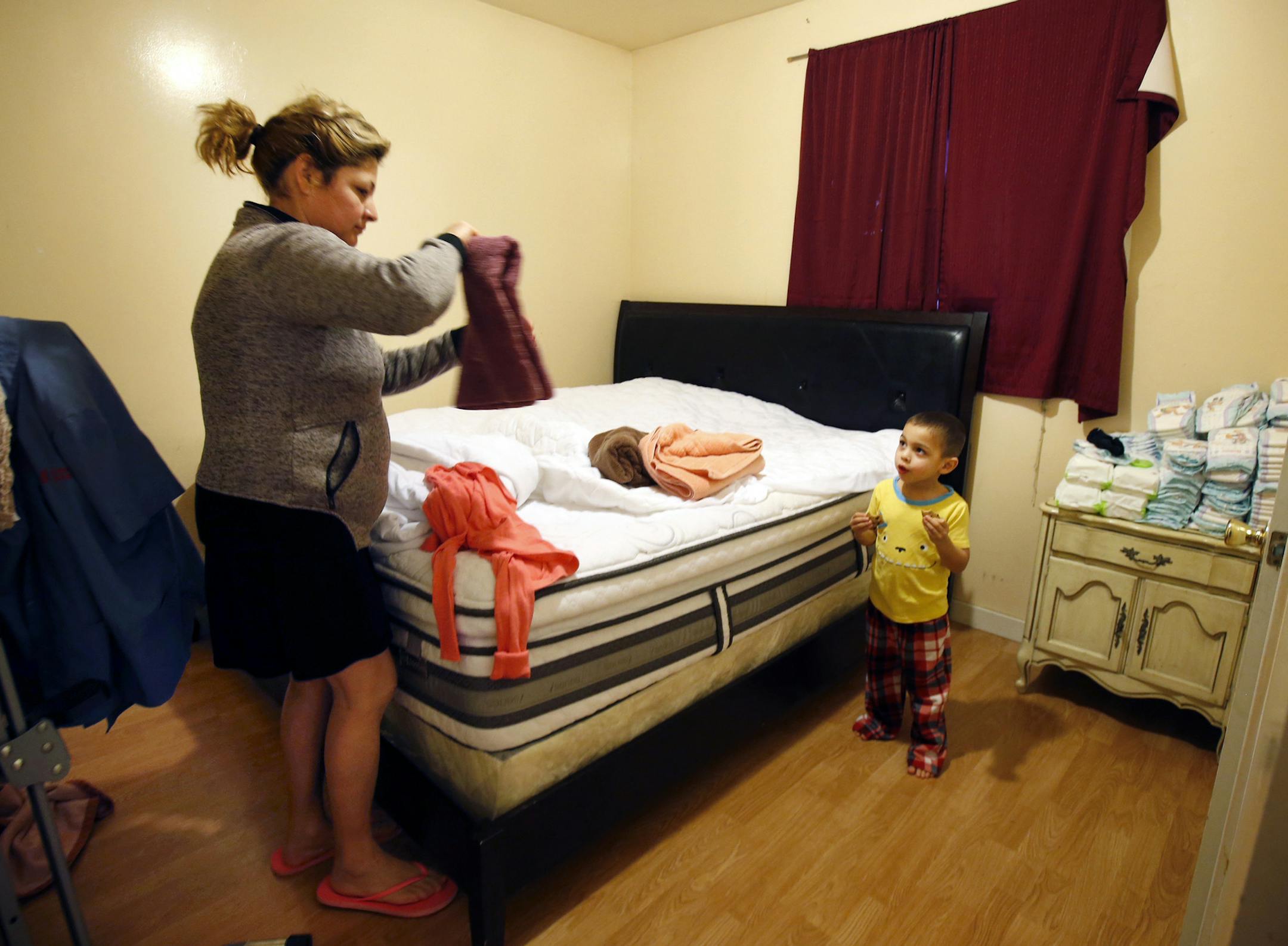 Ana Navarro, a night shift janitor at Stanford University, does laundry alongside her 3-year-old son, Monday morning, Feb. 6, 2017, inside her 450 square-foot apartment in Alviso, Calif. As rents continue to rise, she and her husband are feeling pressure to move out of Alviso with their two children. (Karl Mondon/Bay Area News Group/TNS) ORG XMIT: 1199618