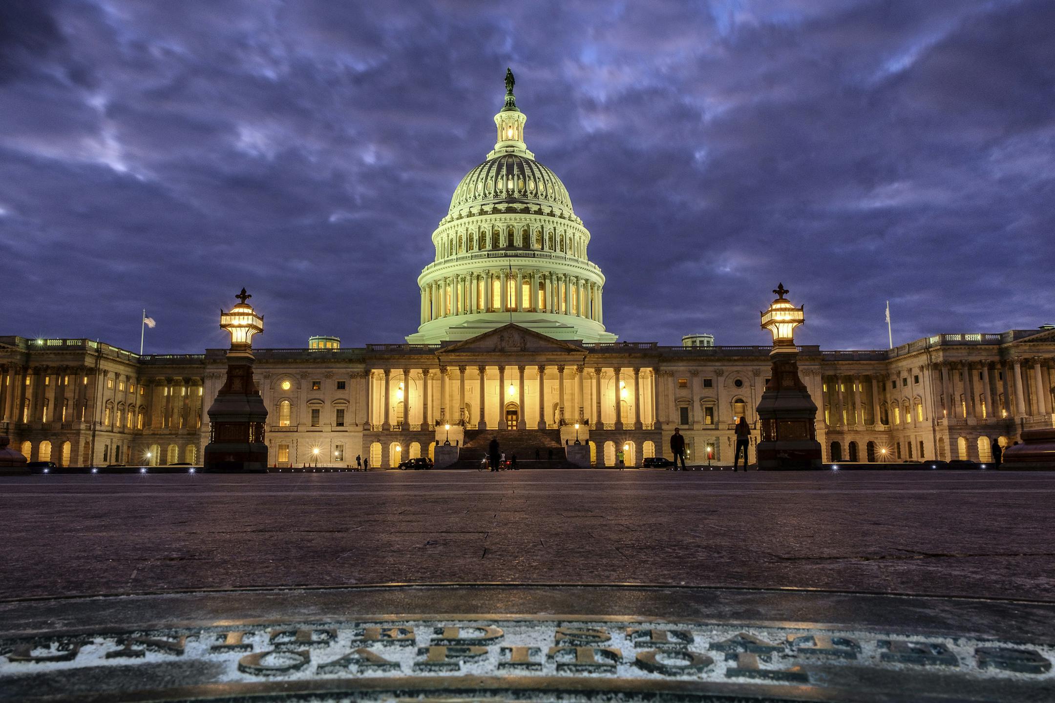Lights shine inside the U.S. Capitol Building as night falls in Washington, Sunday, Jan. 21, 2018 and Congress continues to negotiate during the second day of the federal government shutdown. (AP Photo/J. David Ake)