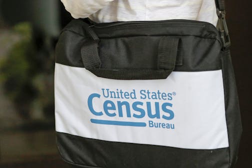 A briefcase of a census taker is seen as she knocks on the door of a residence Tuesday, Aug. 11, 2020, in Winter Park, Fla.