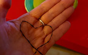 The author snapped this photo of the yarn bracelet her daughter made her the night it broke after nearly 10 years of wear.