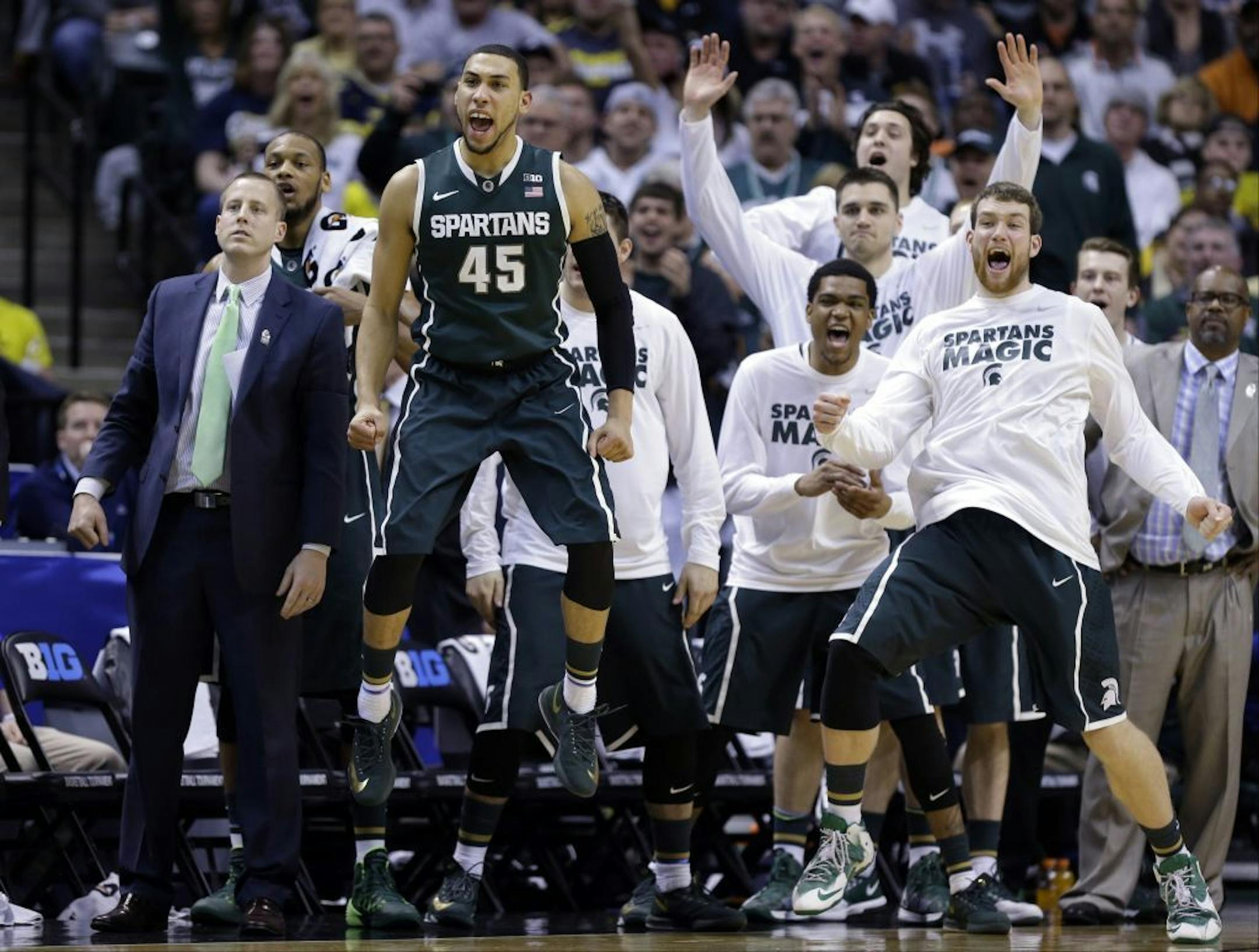 Players on the Michigan State bench reacted in the second half while beating Michigan in the Big Ten championship game Sunday in Indianapolis.