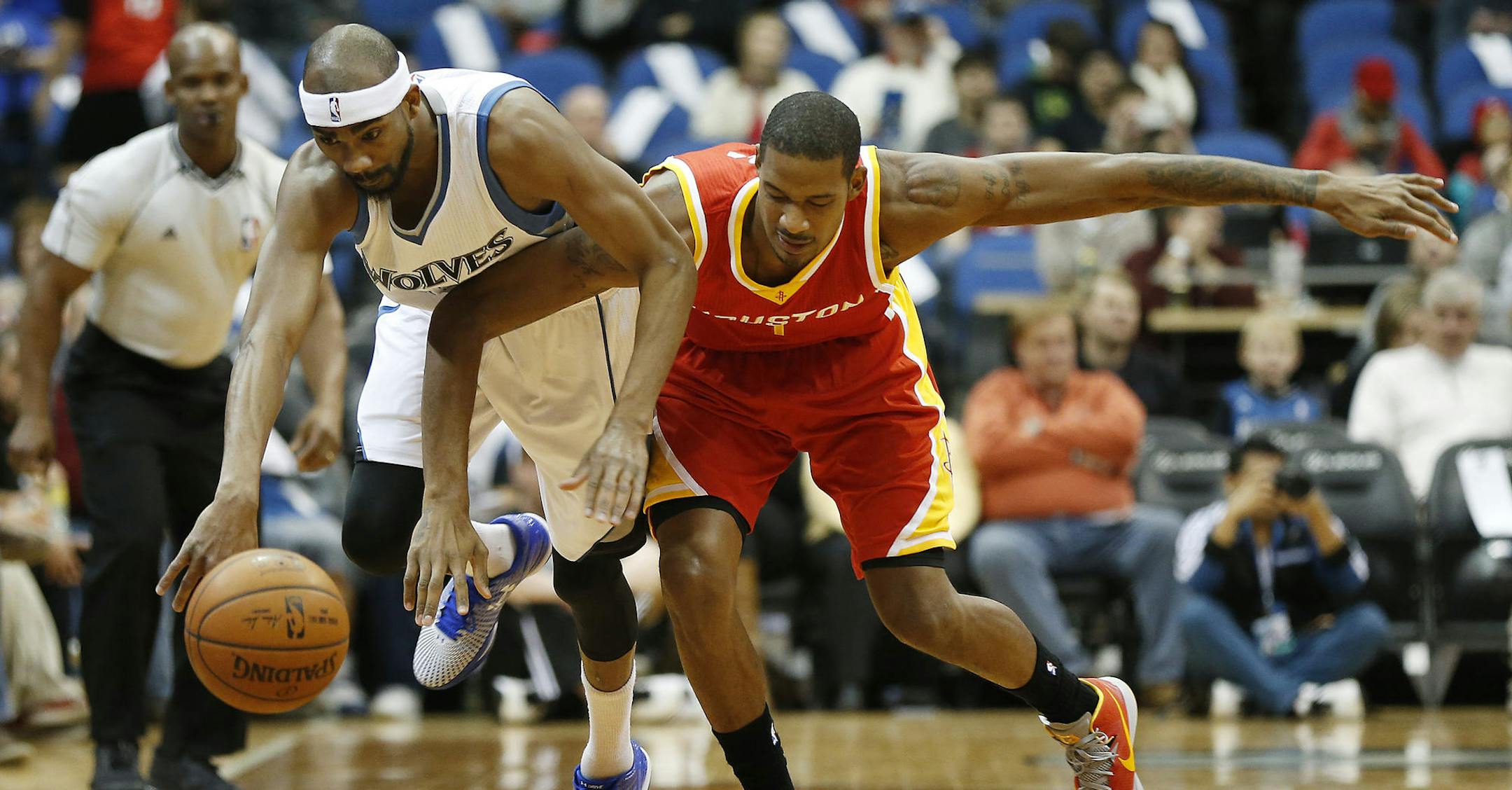 Minnesota Timberwolves forward Corey Brewer, left, steals the ball from Houston Rockets forward Trevor Ariza (1) during the first half of an NBA basketball game Friday, Dec, 5, 2014, in Minneapolis. (AP Photo/Stacy Bengs)