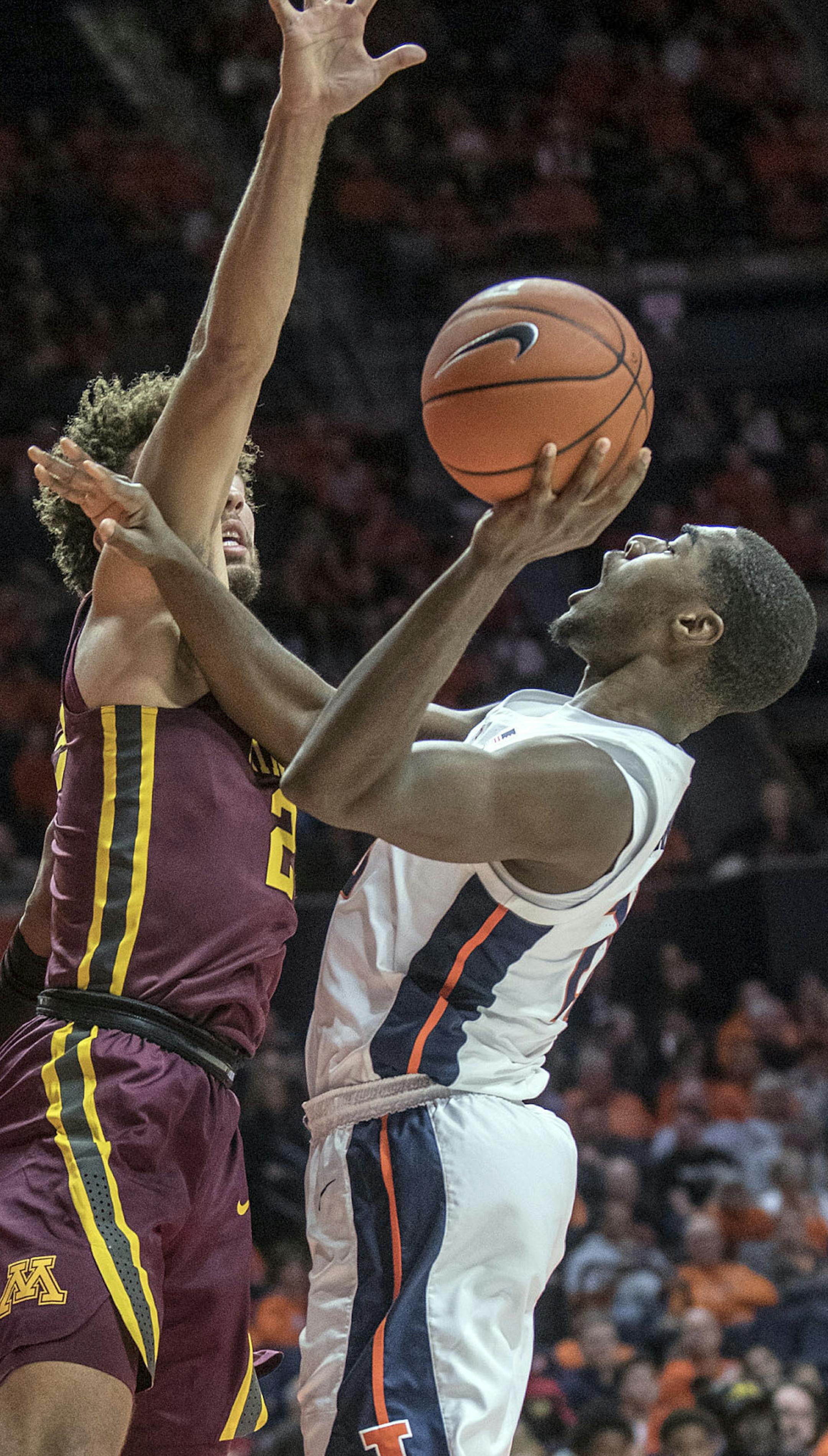 Illinois guard Da'Monte Williams (20) tries to muscle up a shot on Minnesota guard Gabe Kalscheur (22) during the first half of an NCAA college basketball game in Champaign, Ill., Wednesday, Jan. 16, 2019. (AP Photo/Rick Danzl)