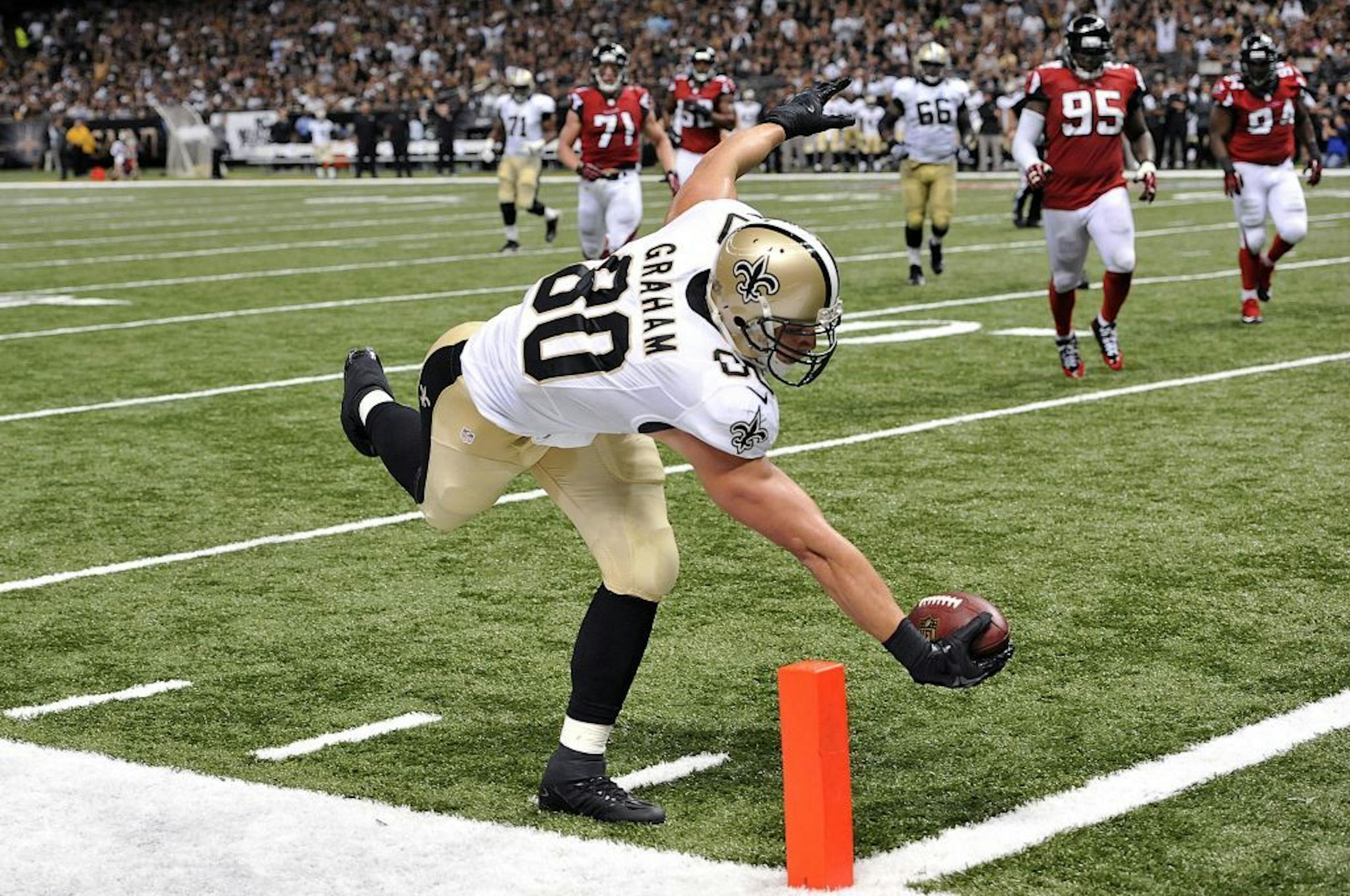New Orleans Saints tight end Jimmy Graham (80) reaches over the pylon to score a touchdown on a pass play in the second half of an NFL football game against the Atlanta Falcons in New Orleans, Sunday, Sept. 8, 2013.