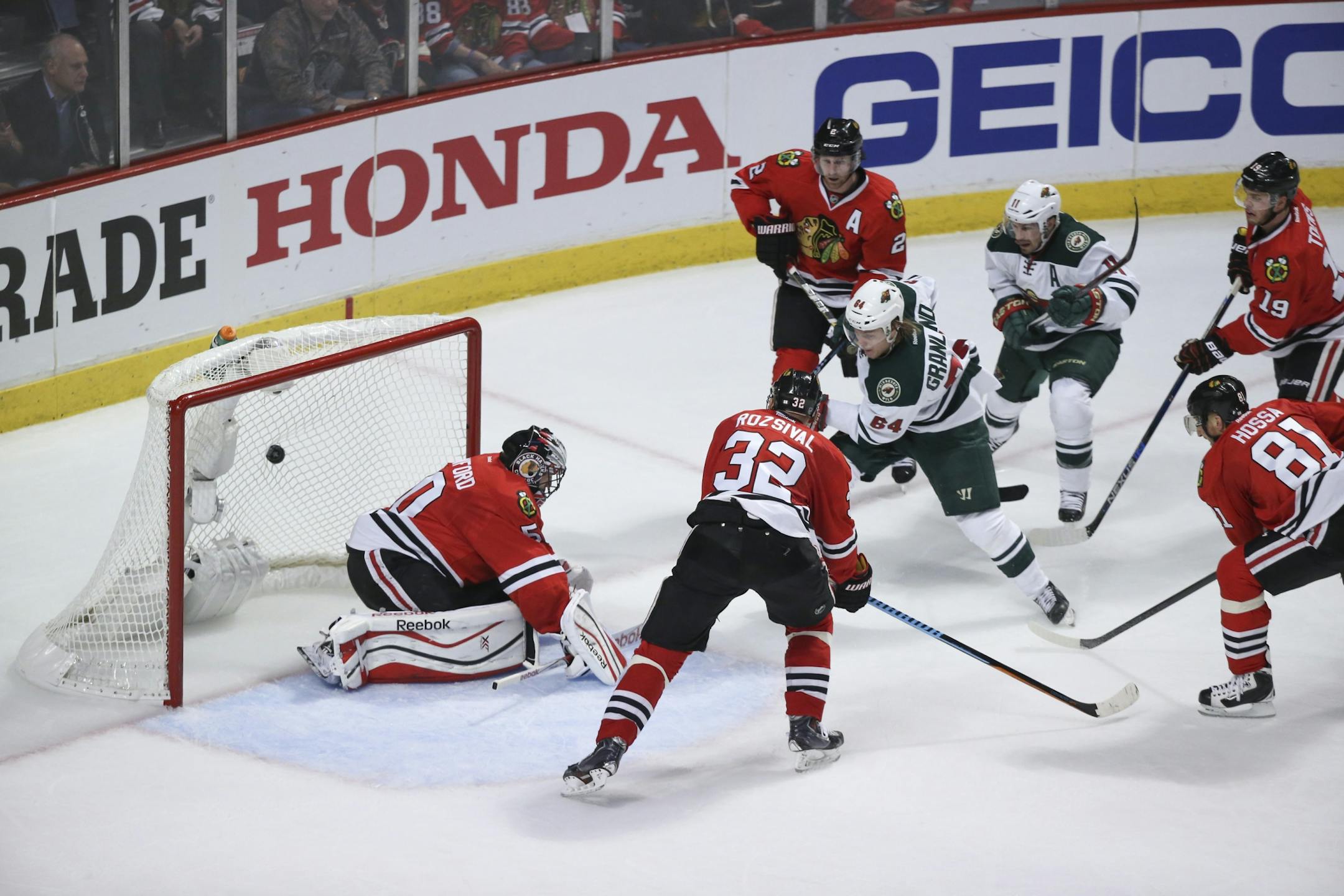 Wild center Mikael Granlund (64) put the puck past Blackhawks goalie Corey Crawford for the Wild's third goal of the second period, tying Chicago 3-3 Friday night.