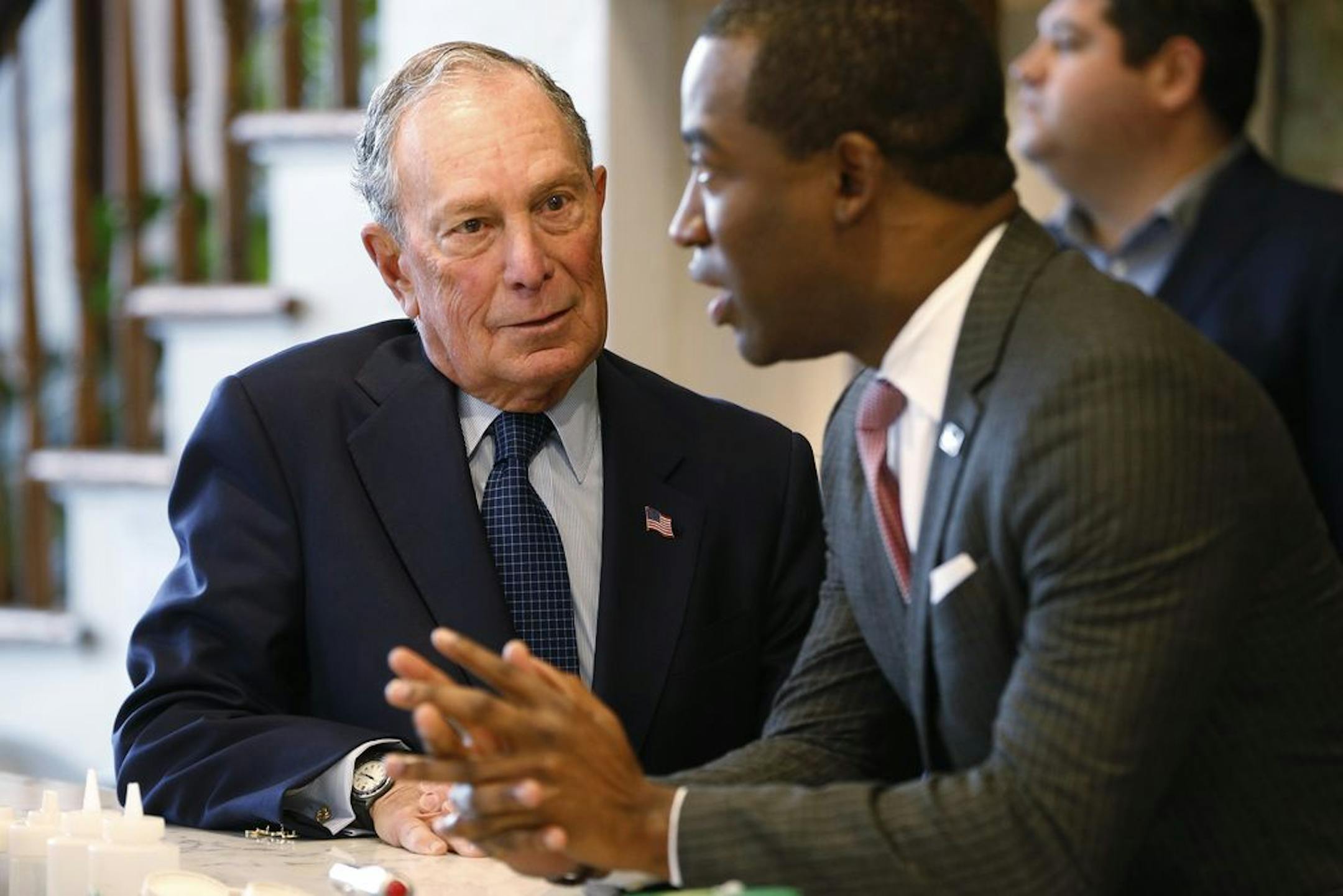 Democratic presidential candidate, former New York Mayor Michael Bloomberg, left, chats with Richmond Mayor Levar Stoney at a coffee shop in Richmond, Va., Tuesday, Jan. 7, 2020.