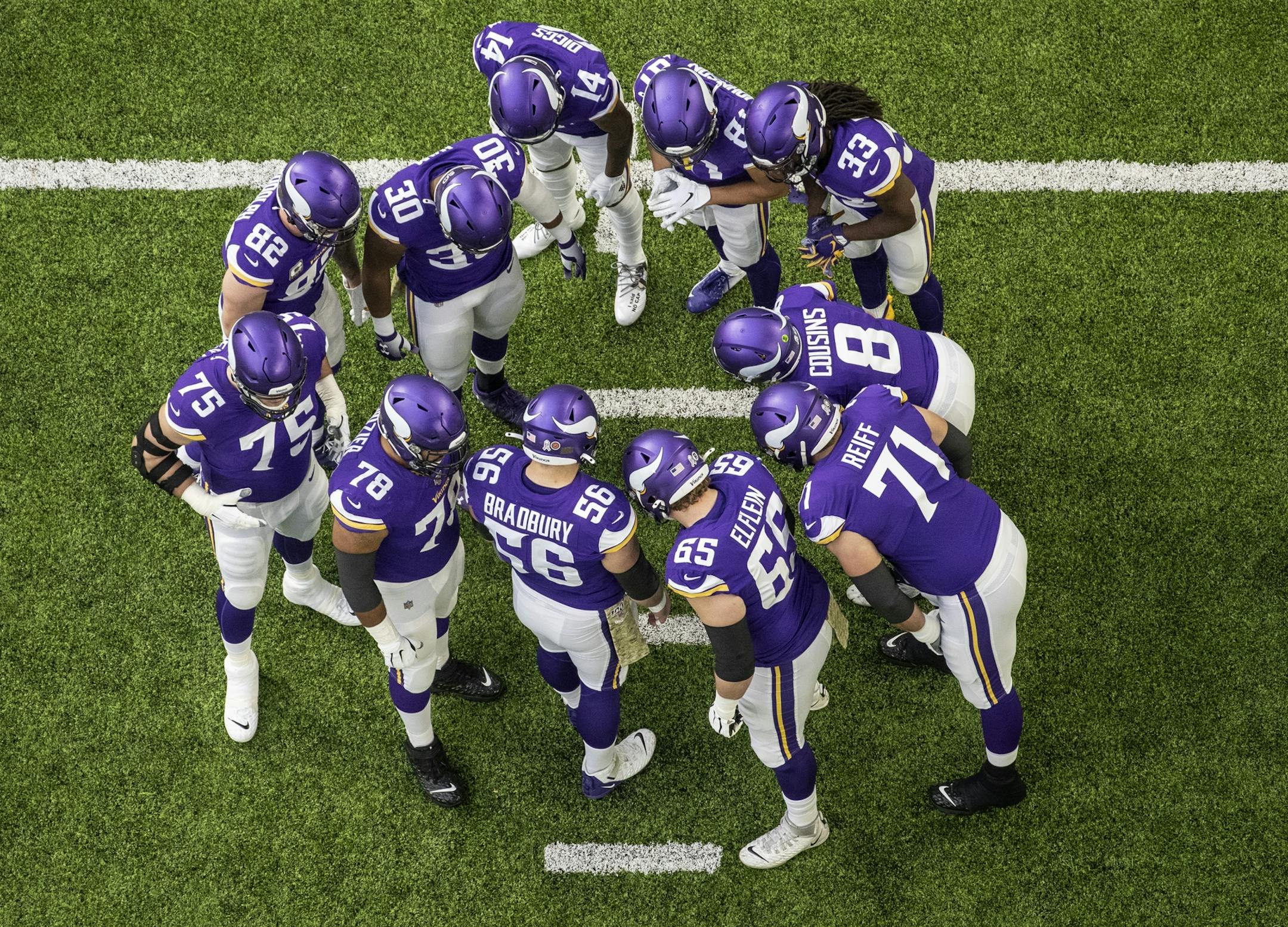 The Minnesota Vikings offense huddled around Kirk Cousins (8) during their game against Denver.